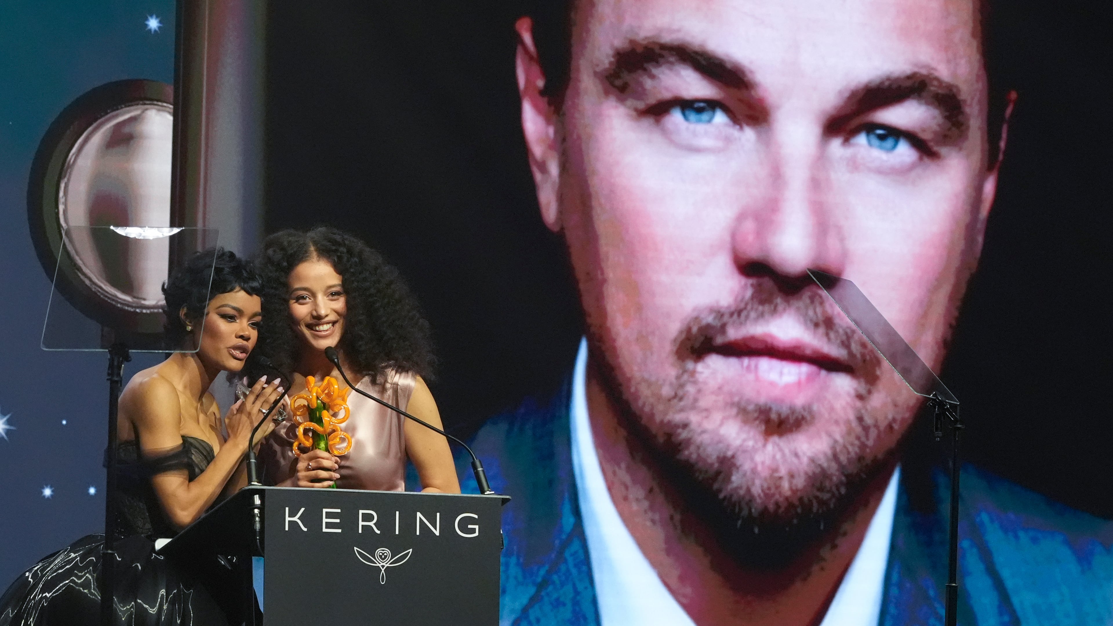 Teyana Taylor, left, and Chase Infiniti accept the desert palm achievement award on behlaf of Leonardo DiCaprio during the 37th Palm Springs International Film Festival Film Awards on Saturday, Jan. 3, 2026 at Palm Springs Convention Center in Palm Springs, Calif. (AP Photo/Chris Pizzello)