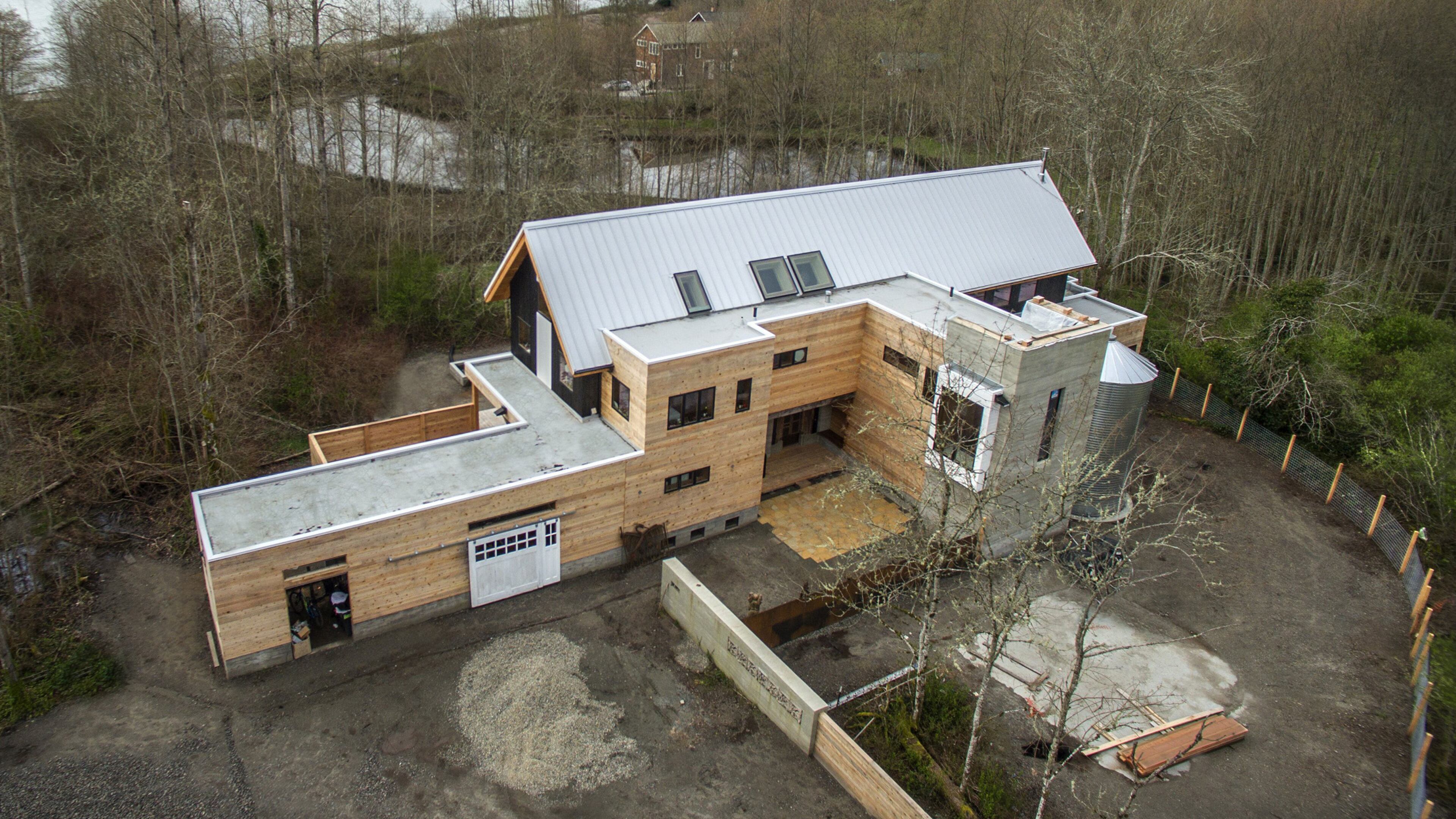 Heron Hall sits on an acre or so on Bainbridge Island, with a trail easement through the property, a restored salmon creek and a south-facing view of Rich Passage. “This is the point where Captain Vancouver and Chief Kitsap parlayed,” Jason F. McLennan says. “Now, most of Bainbridge shoreline is privatized, but the previous owner had a vision that the beach should be for everyone, which we completely agreed with. We are happy that our part of the beach is forever public access, even though it belongs technically to us.” (Steve Ringman/Seattle Times/TNS)