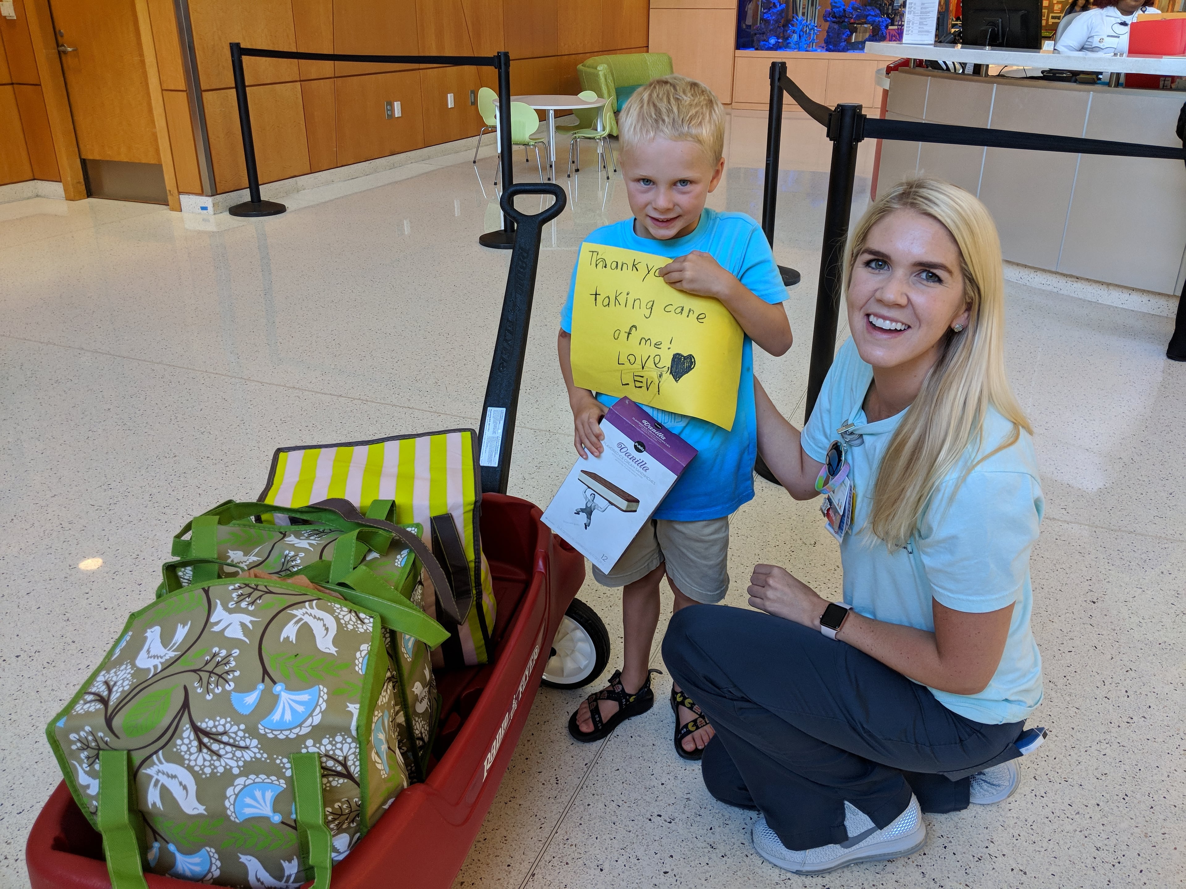 Here’s Levi with Shelbey Fanning, one of his PICU nurses from his hospital stay in 2014. His wagon is full of ice cream sandwiches.