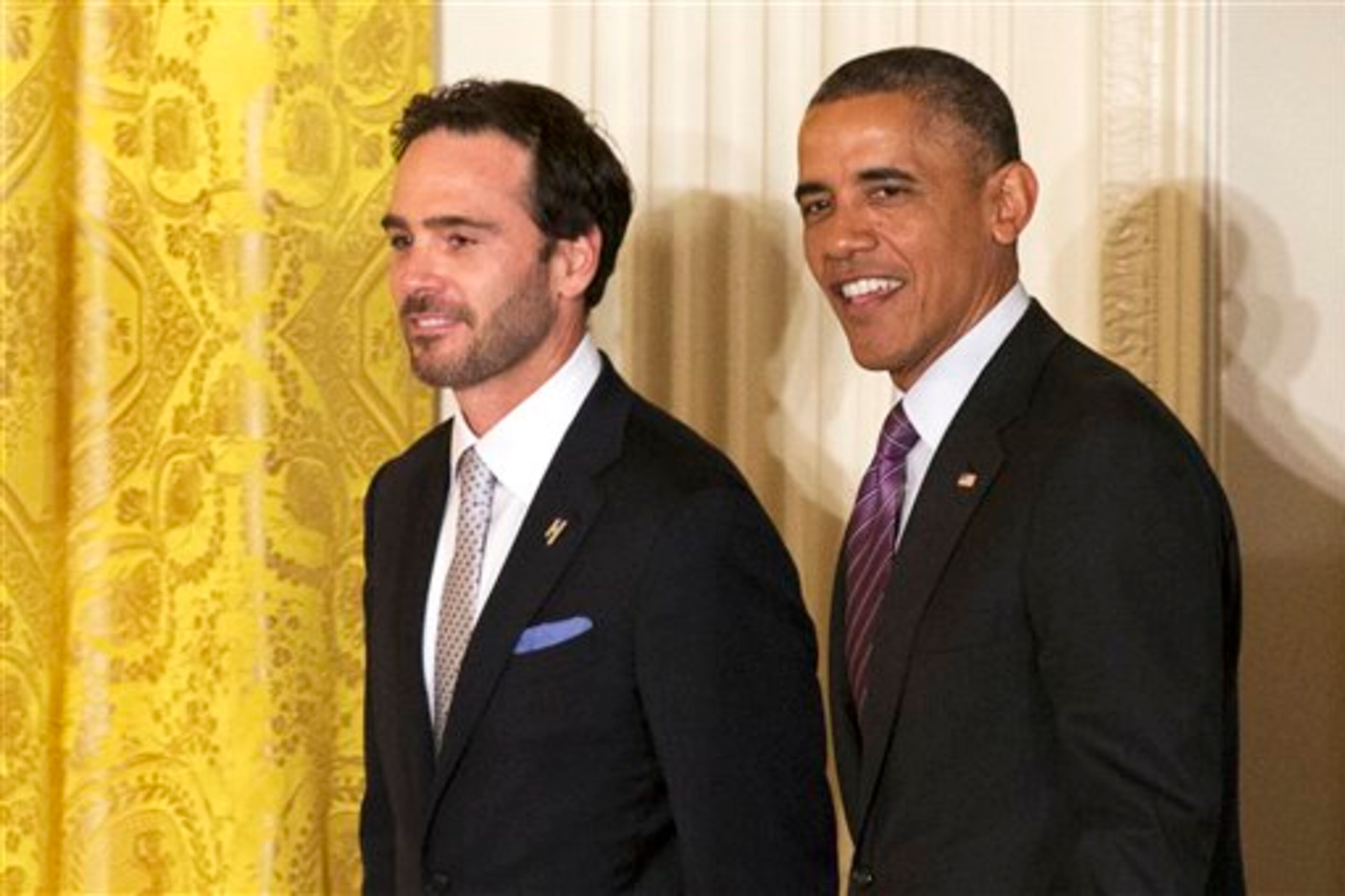 President Barack Obama walks into the East Room of the White House in Washington, Wednesday, June 25, 2014, with NASCAR driver Jimmie Johnson for a ceremony honoring the 2013 NASCAR Sprint Cup Series champions. (AP Photo/Jacquelyn Martin)