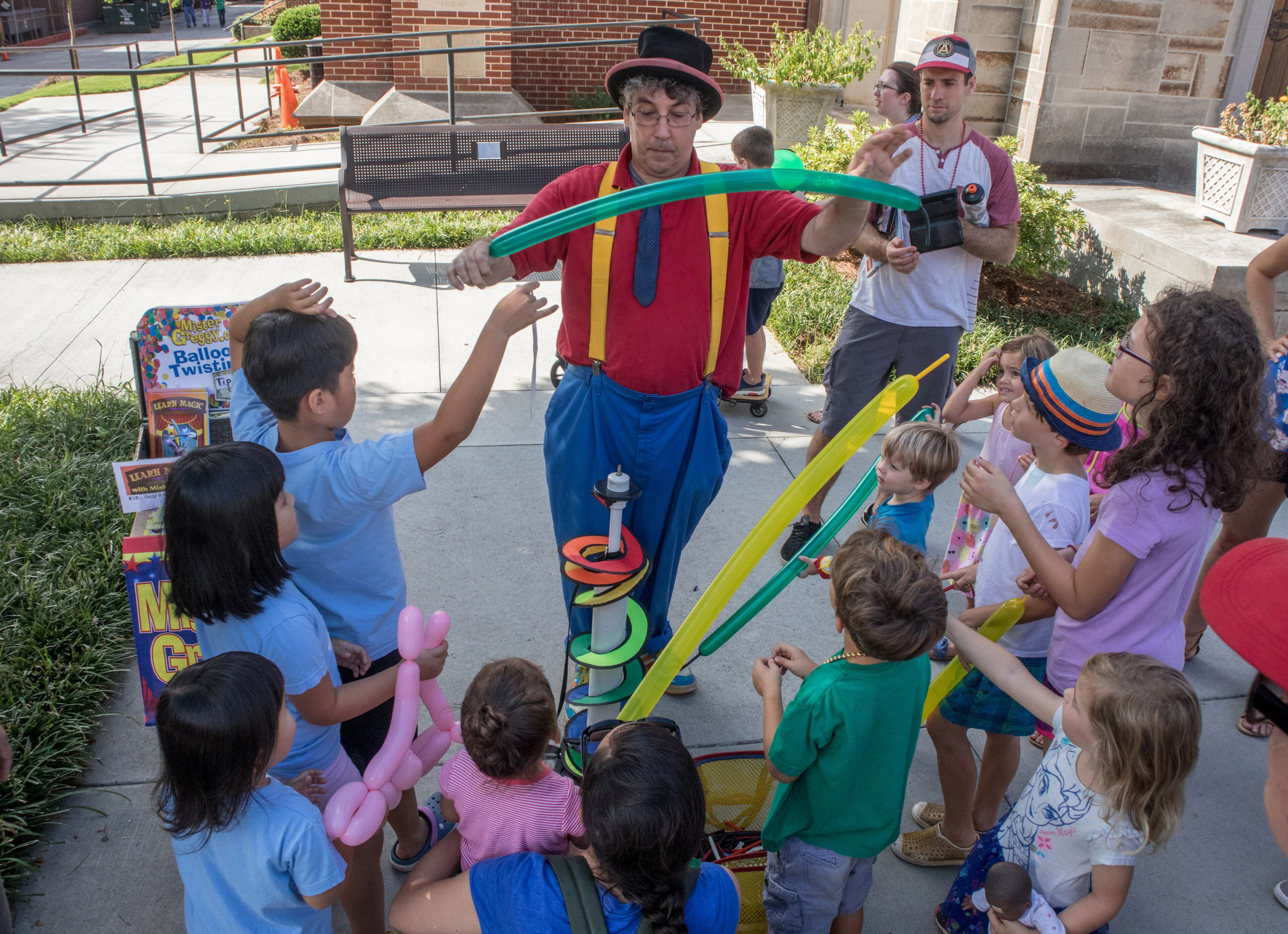Greg McMahan (center) makes balloon figures for kids during the AJC Decatur Book Festival Saturday, September 1, 2018. The festival kicked off Friday night and continues Sunday. (Photo: STEVE SCHAEFER / SPECIAL TO THE AJC)