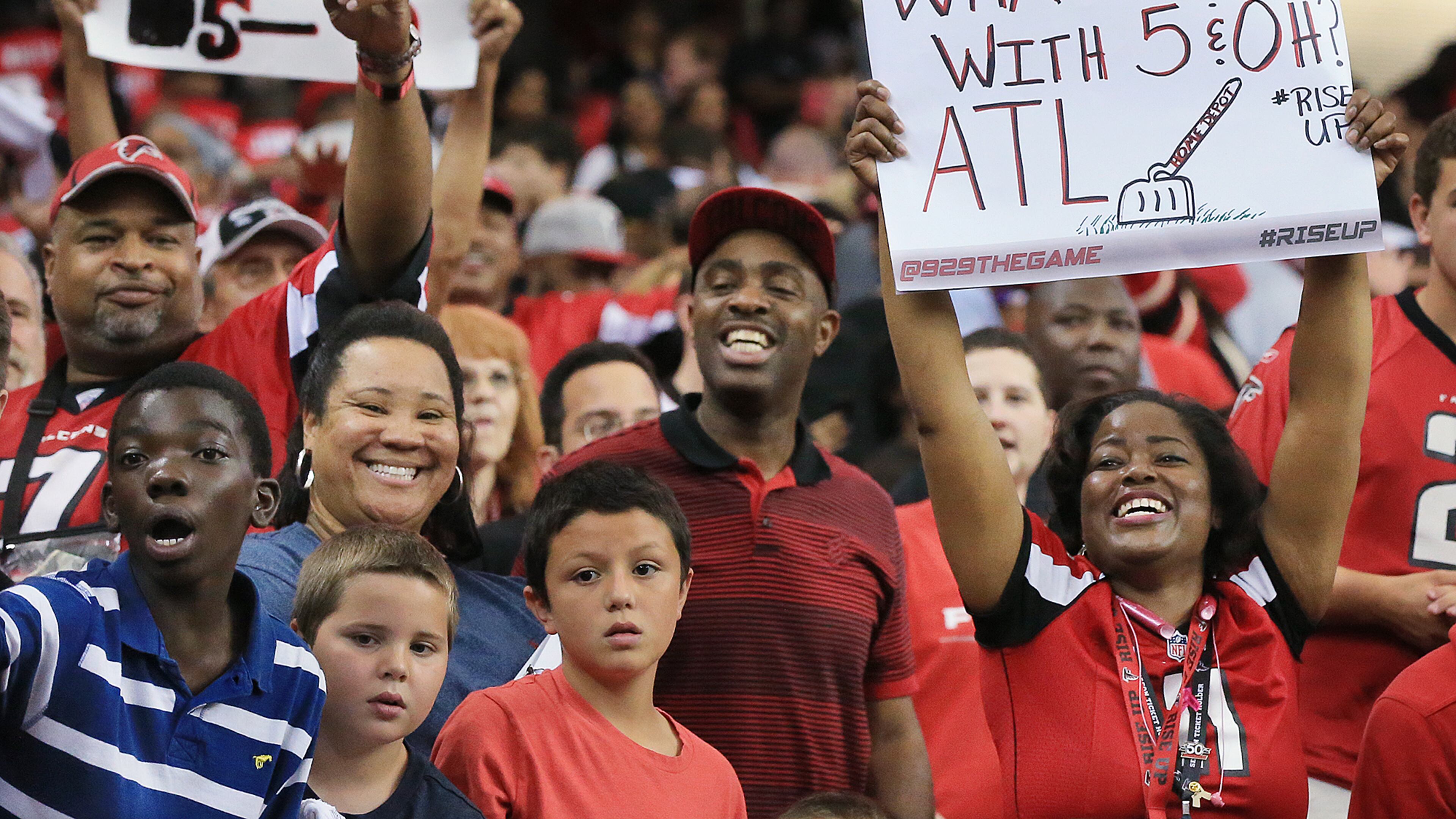 Falcons fans celebrate beating the Redskins 25-19 during sudden death to remain undefeated at 5-0 during their football game on Sunday, Oct. 11, 2015, in Atlanta.