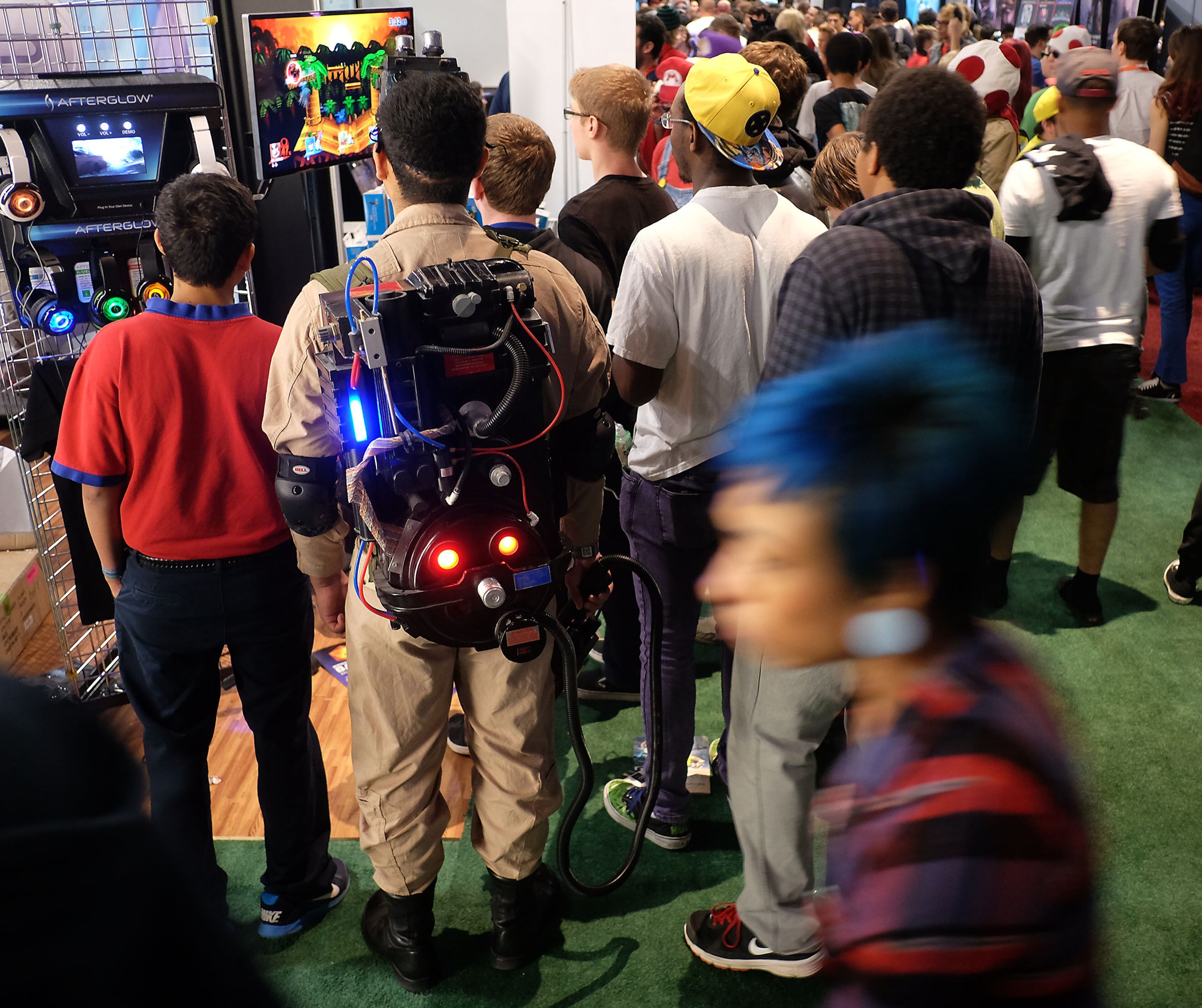 MARCH 14, 2015 - Anthony Villarreal, 23, of Austin, second from left, with Ghostbusters of ATX, left, watches gamers play a video game at South by Southwest Gaming held in Austin, Tx., on Saturday, March 14, 2015. (RODOLFO GONZALEZ / AMERICAN-STATESMAN)