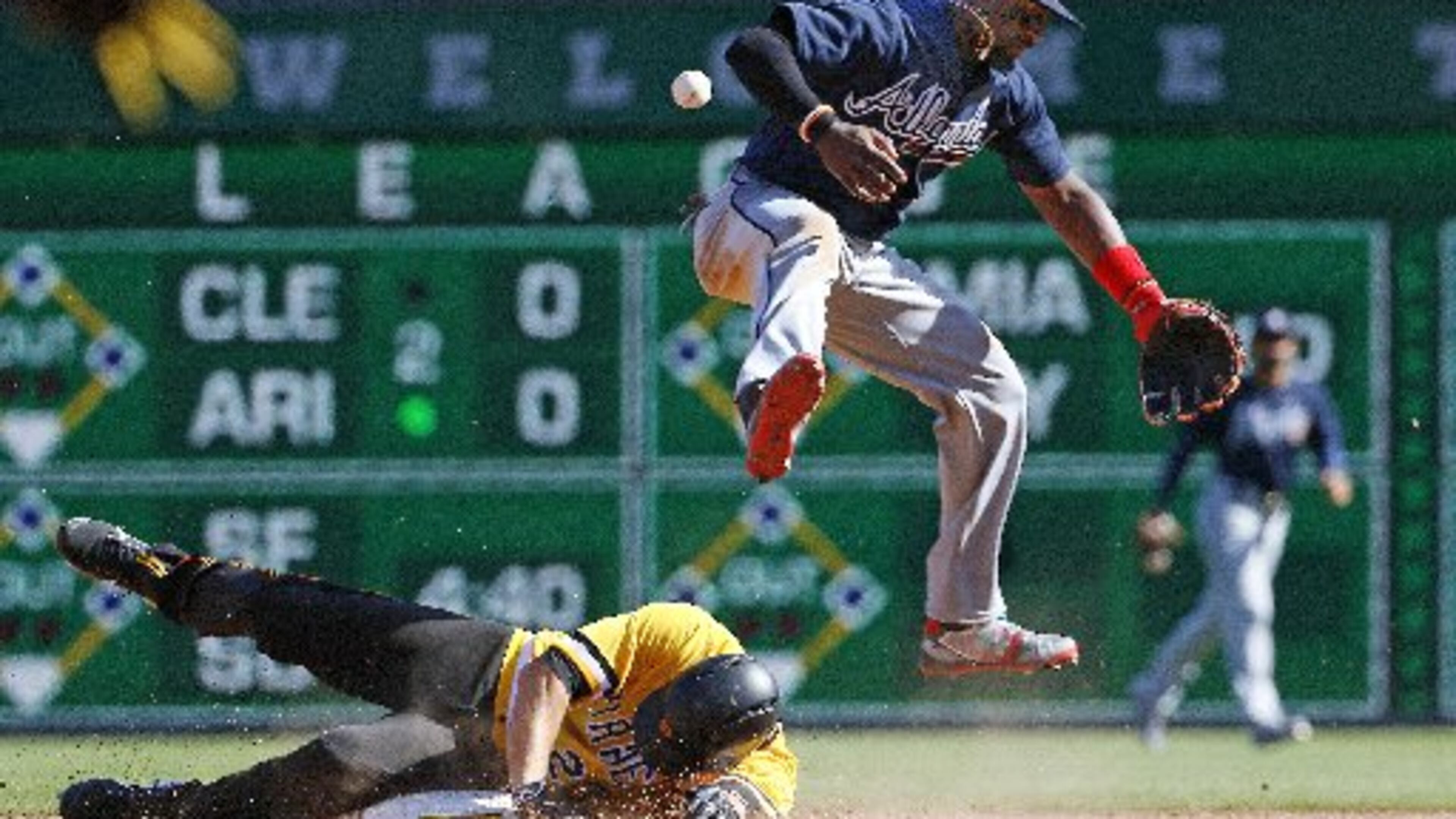 Braves second baseman Brandon Phillips fails to turn a double play in the ninth inning Sunday as David Freese slides. (AP Photo)