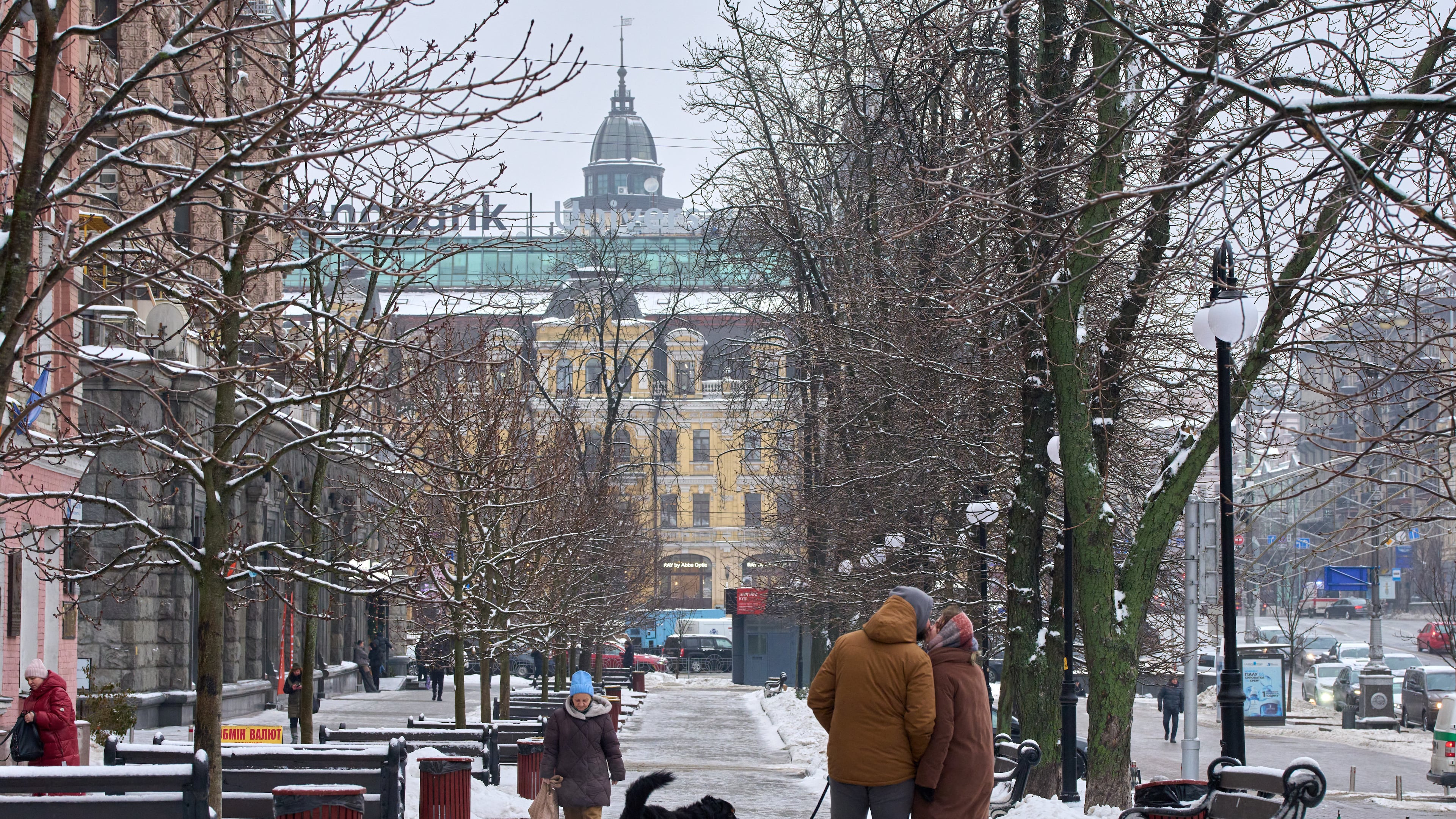 A couple share a tender moment as they walk on a snowy street in Kyiv, Ukraine, Thursday, Jan. 8, 2026, as Ukraine faces harsh weather amid Russia's regular missile attacks on the country's energy system. (AP Photo/Efrem Lukatsky)