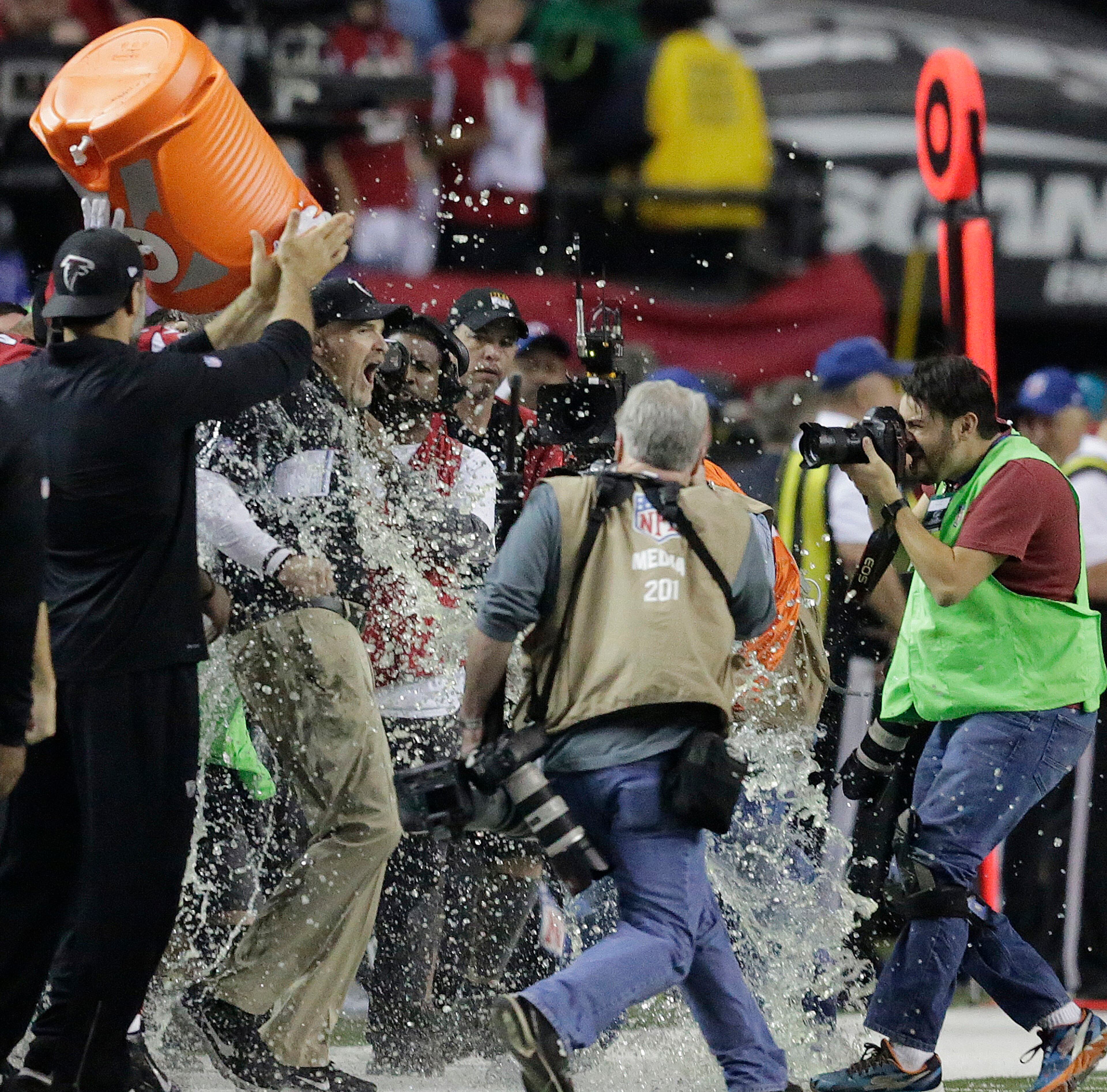 Atlanta Falcons head coach Dan Quinn reacts as he is dunked after the NFL football NFC championship game against the Green Bay Packers Sunday, Jan. 22, 2017, in Atlanta. The Falcons won 44-21 to advance to Super Bowl LI.(AP Photo/David Goldman)