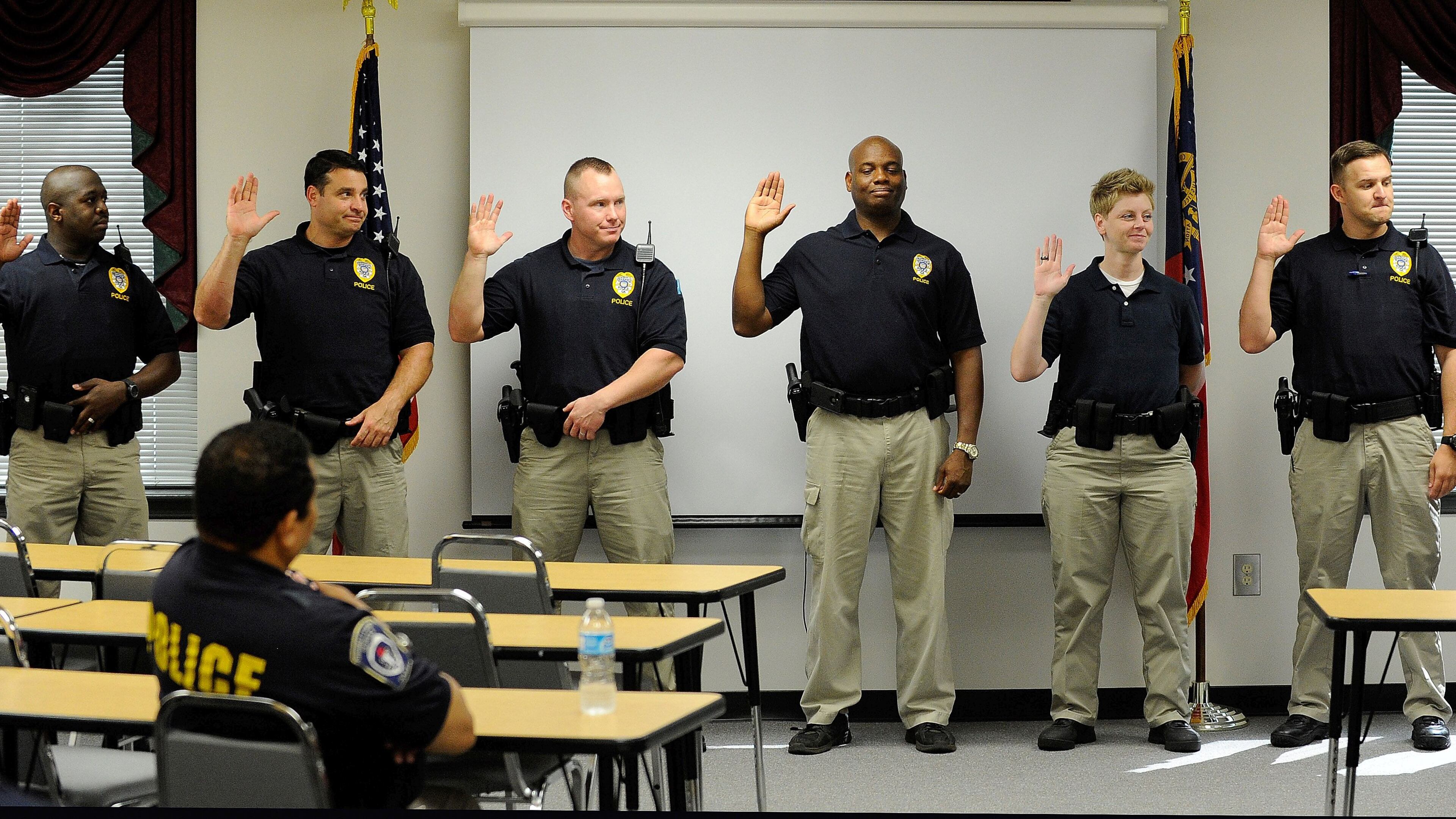 Gwinnett County school resource officers are sworn in for the 2014-15 school year. David Tulis / AJC Special