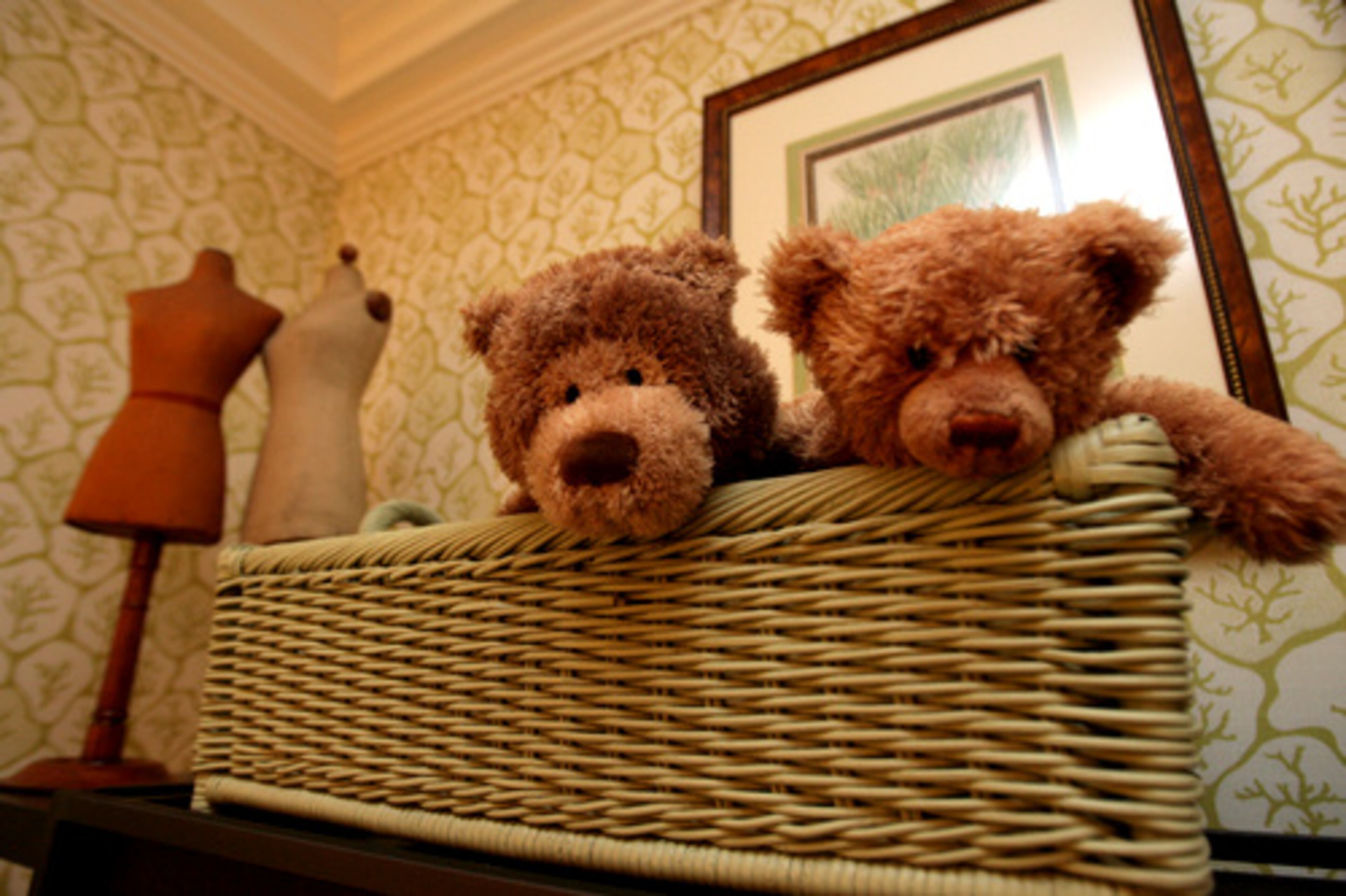 Behind the children's toys, walls are covered in a playful celery and cream Zoffany fabric.