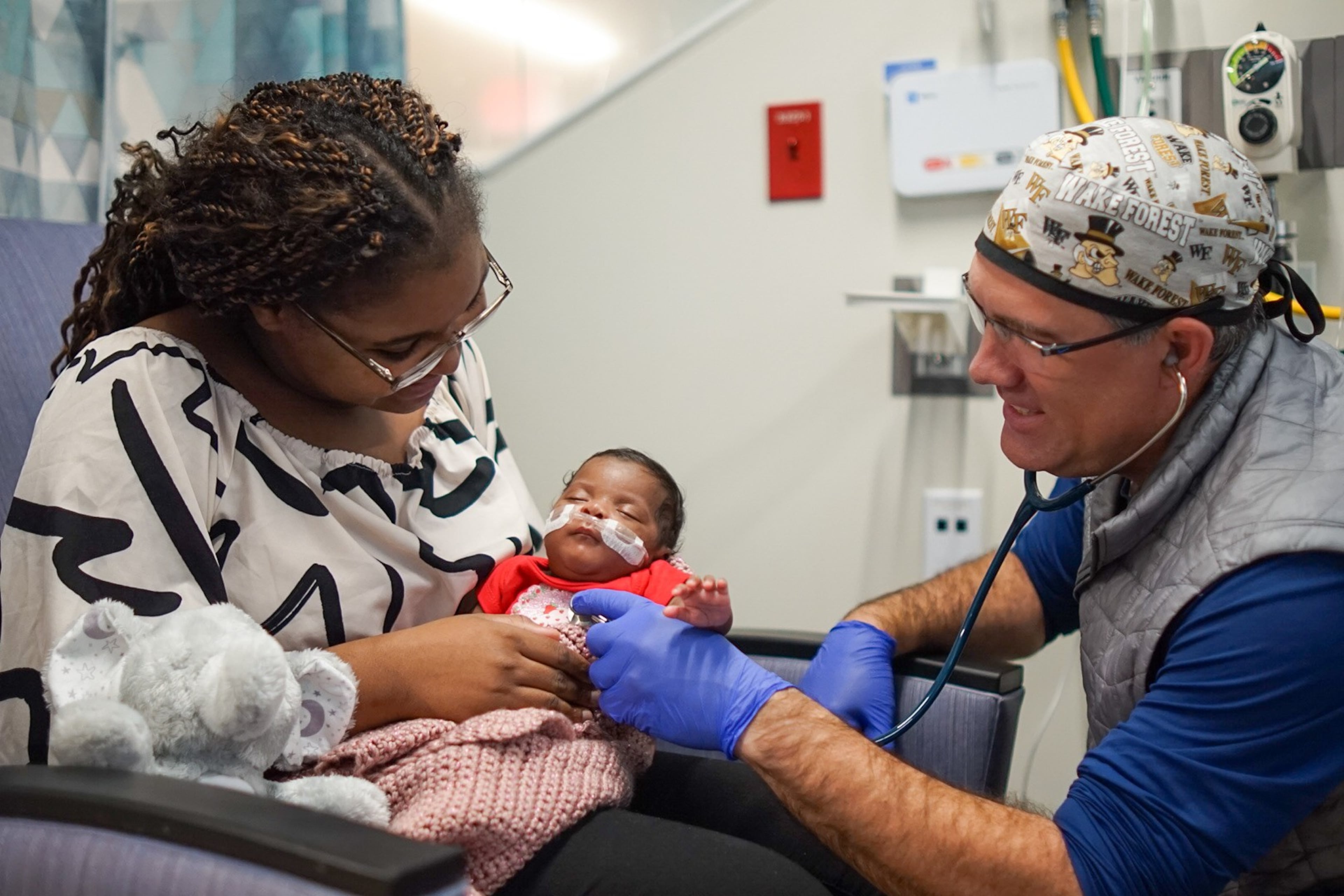 Dr. Brad Buckler examines Tianna Nunnally’s baby, Sky, at the Memorial Health University Medical Center’s Dwaine and Cynthia Willett Children’s Hospital neonatal intensive care unit in Savannah. (Courtesy of Tre Windom)
