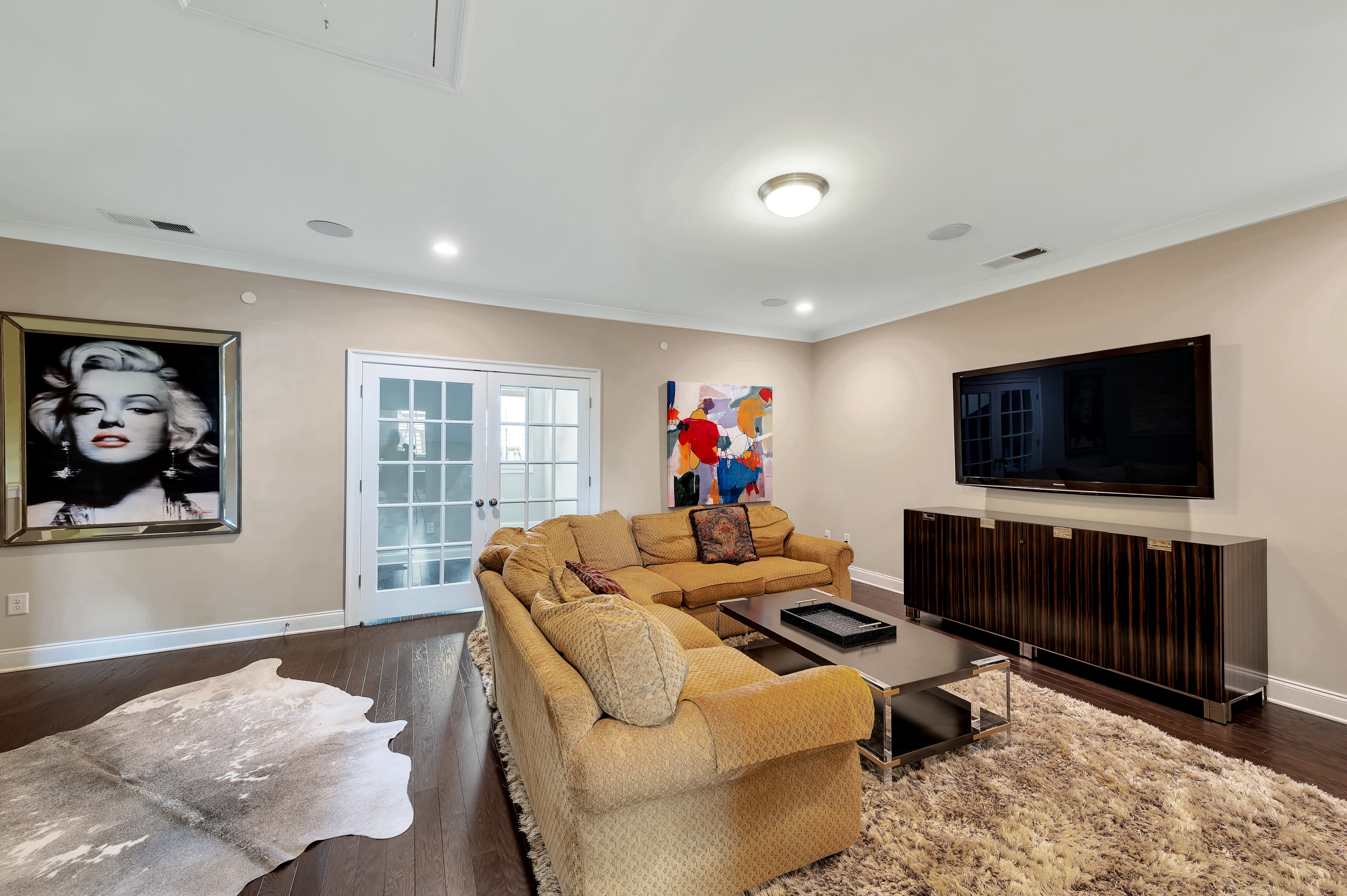 Located on the lower level, the family room is spacious and has access to the outside. Text by Stacy Perkinson and Julie Pedersen