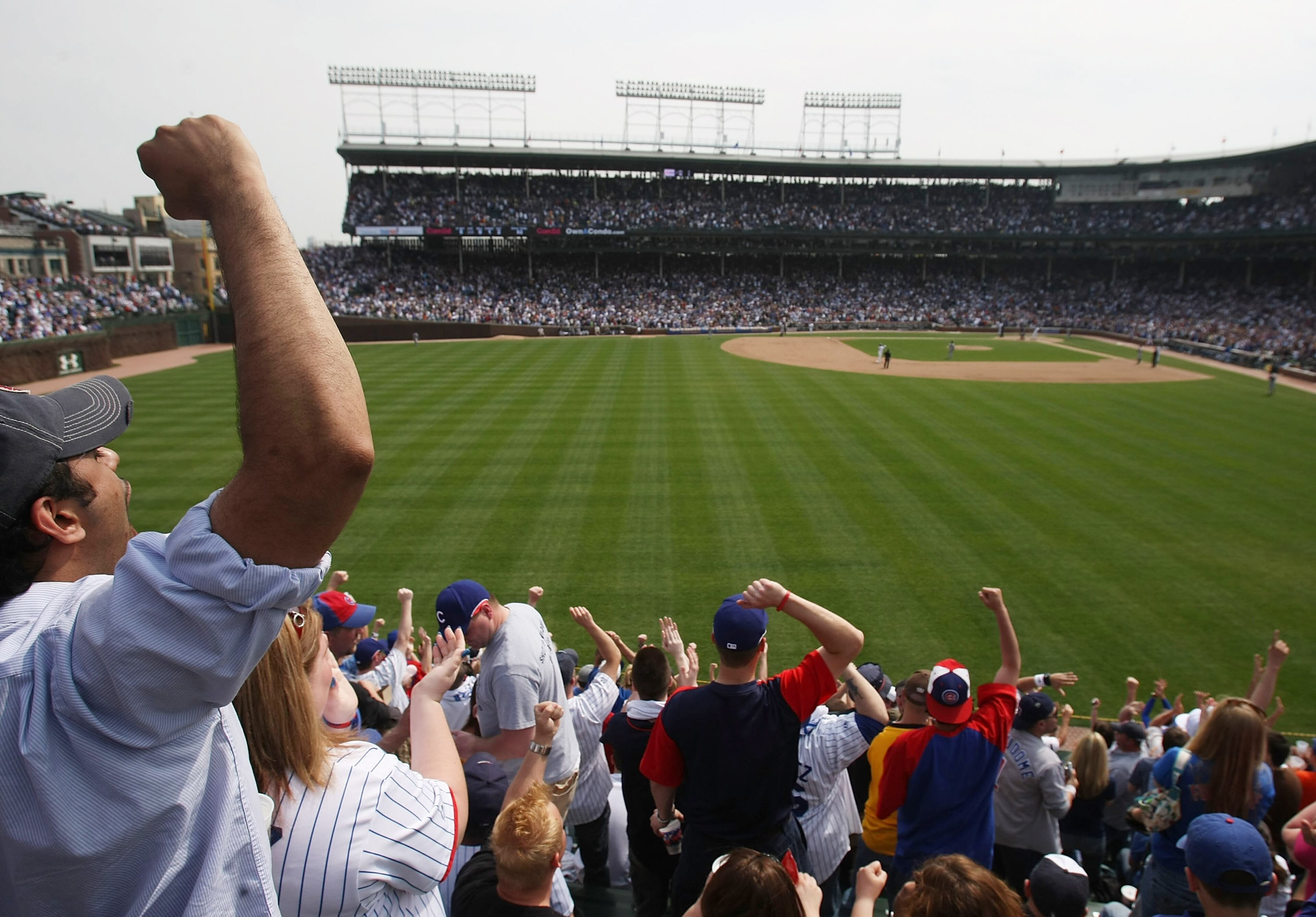 CHICAGO - APRIL 22: Fans in the left field bleachers cheer as the Chicago Cubs score runs in the 4th inning against the New York Mets on April 22, 2008 at Wrigley Field in Chicago, Illinois. (Photo by Jonathan Daniel/Getty Images)
