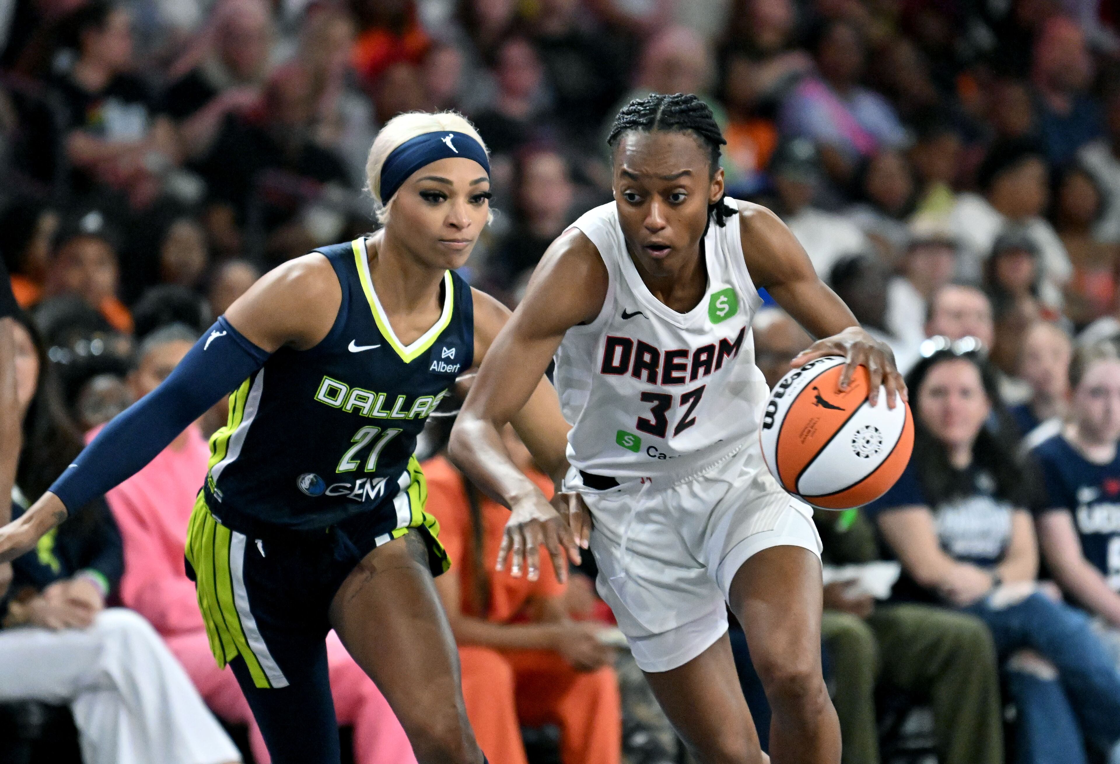 Atlanta Dream guard Shatori Walker-Kimbrough (32) drives against Dallas Wings guard DiJonai Carrington (21) during the second half in a WNBA basketball game at Gateway Center Arena, Saturday, May 24, 2025, in Atlanta. Atlanta Dream won 83-75 over Dallas Wings. (Hyosub Shin / AJC)