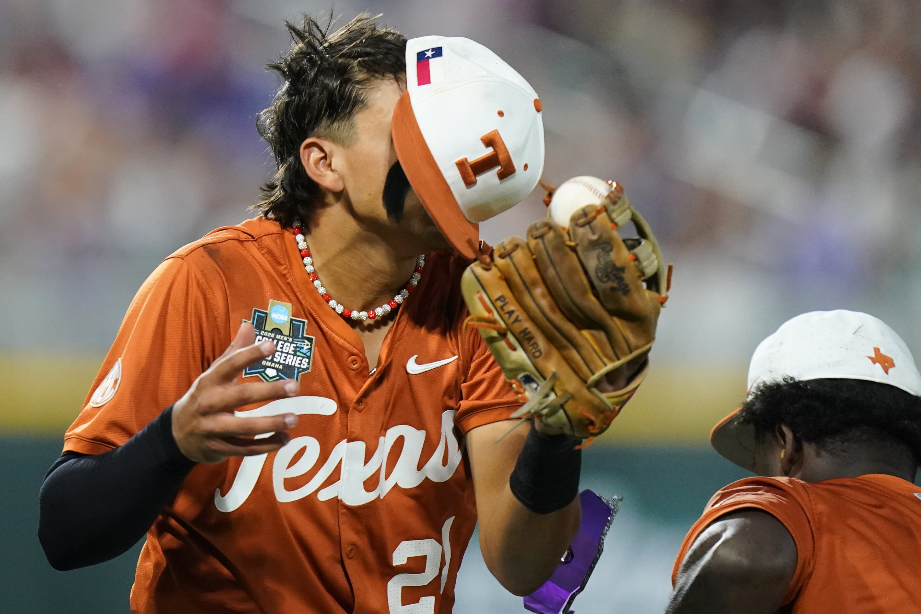 Texas infielder Adrian Rodriguez (24) makes the catch while colliding with outfielder Anthony Pack Jr. (6) during an NCAA baseball College World Series elimination game against Georgia, Tuesday, June 16, 2026 in Omaha, Neb. Georgia won 2-0. (AP Photo/Vera Nieuwenhuis)