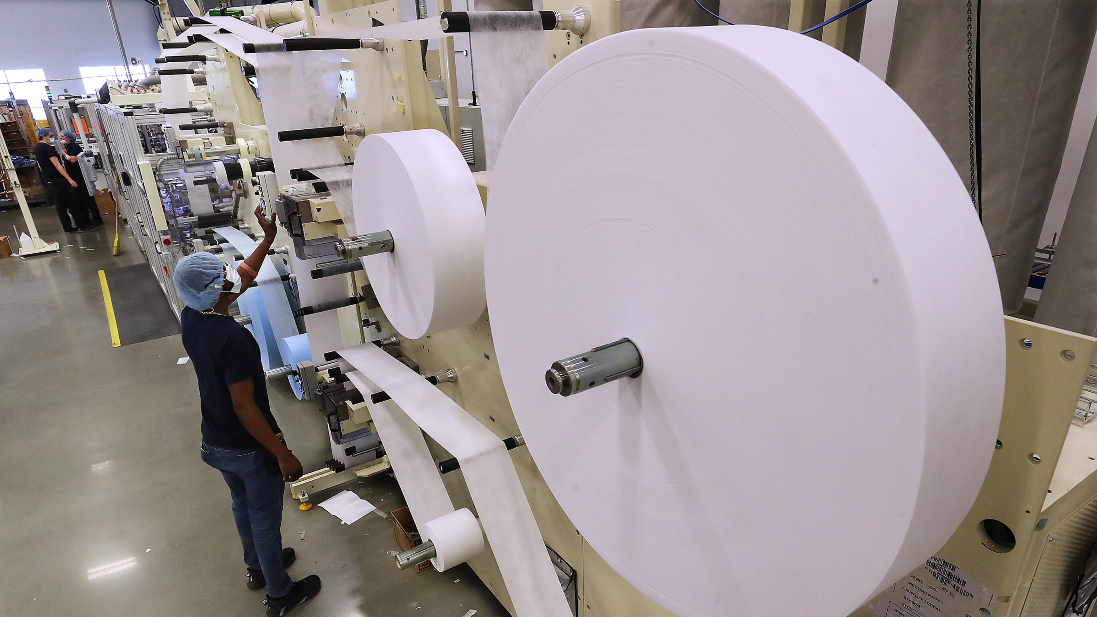 Xavier Jordan loads non-woven material for faces masks on production line 12 at Medline on Monday, Sept 20, 2021, in Lithia Springs. Medline has grown dramatically from 2 production lines and 20 employees to 12 production lines and nearly 500 employees. “Curtis Compton / Curtis.Compton@ajc.com”