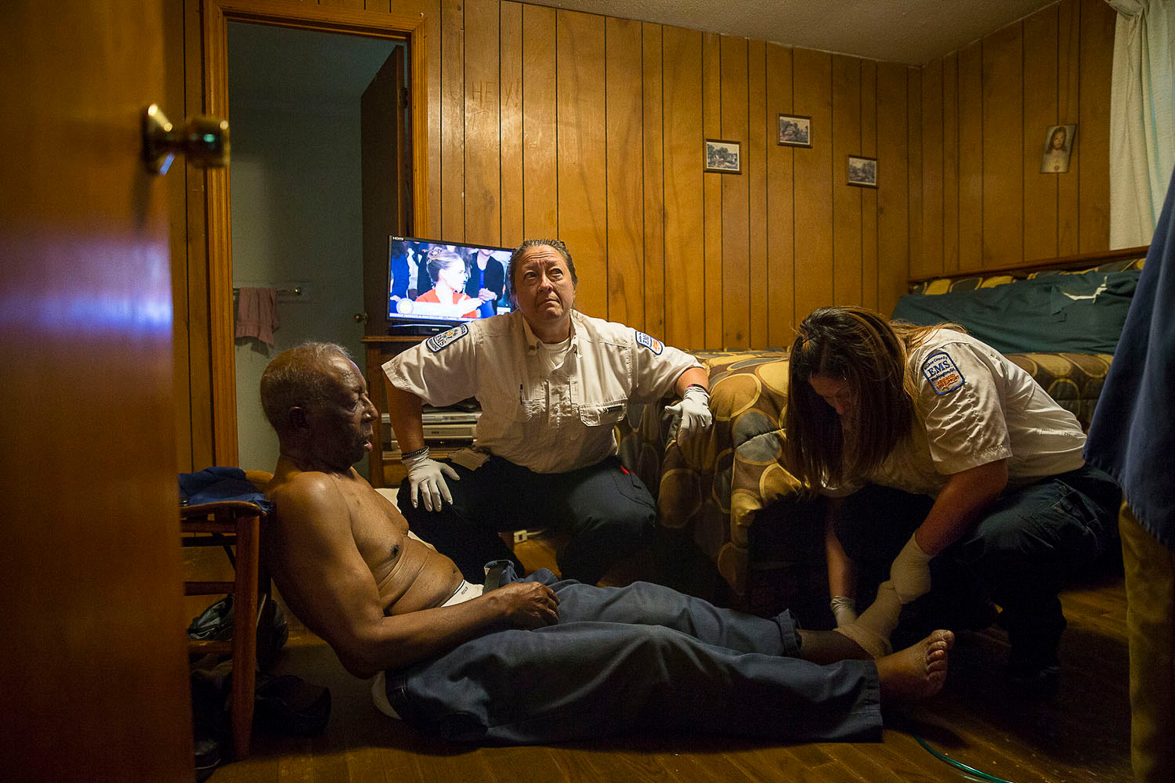 10/03/2019 -- Washington, Georgia -- Wilkes County paramedic Rebekah Echols (right) helps prepares James Gilmore (left), 86, for a lift as Wilkes County Deputy EMA Director and paramedic Amy Howard (center) listens to his wife, Jessie Gilmore, 80, (not photographed) explain how James had early morning fall at their residence, Thursday, October 3, 2019. Amy says Wilkes County has a large elderly population and some of their morning calls are for falls. (Alyssa Pointer/Atlanta Journal Constitution)