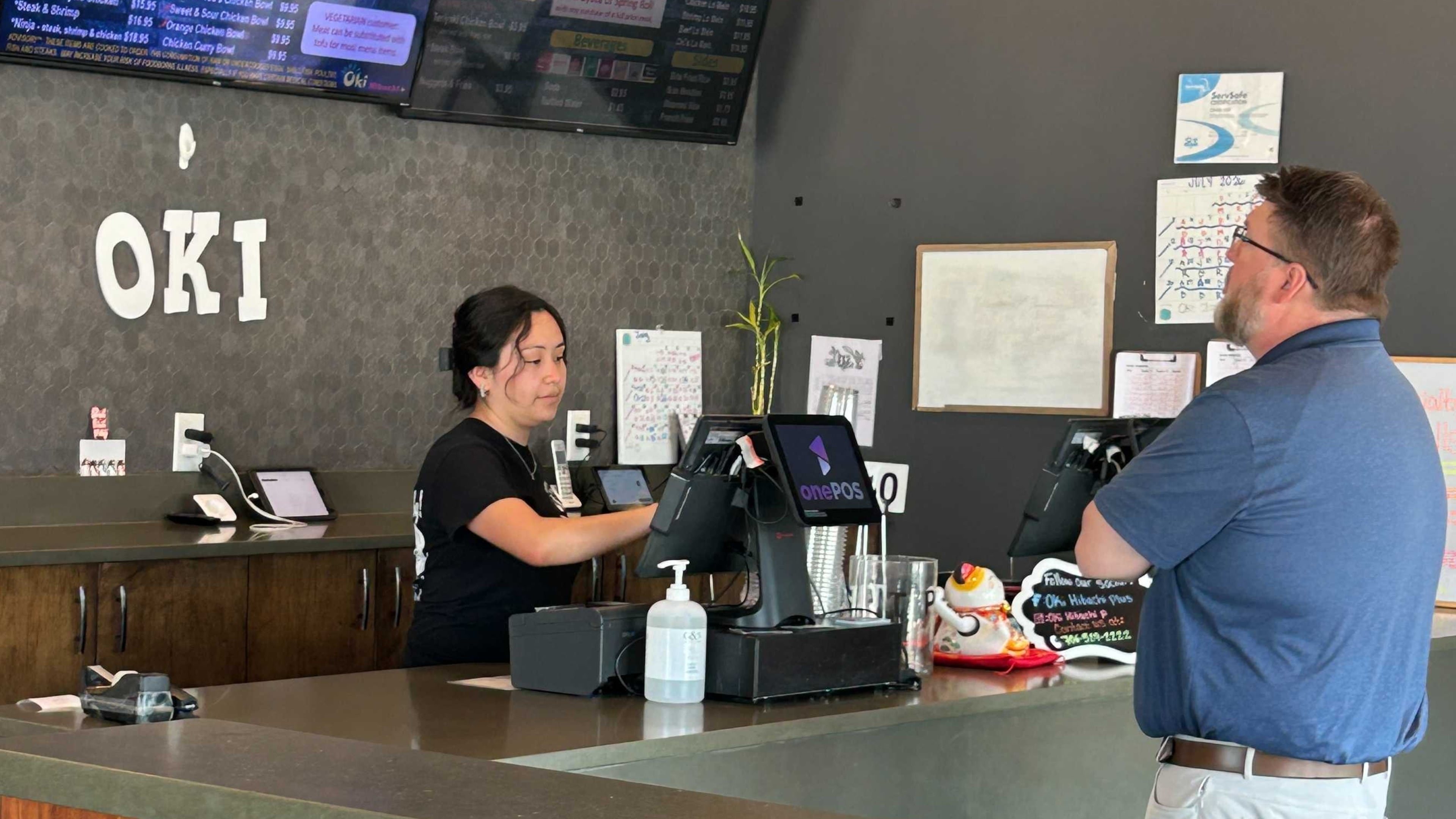 Karen Ajanel serves a customer at her job. Ajanel, a Dalton State College student, credits the Orange Duffel Bag Initiative, credits the program with helping in her academic journey. (Courtesy)