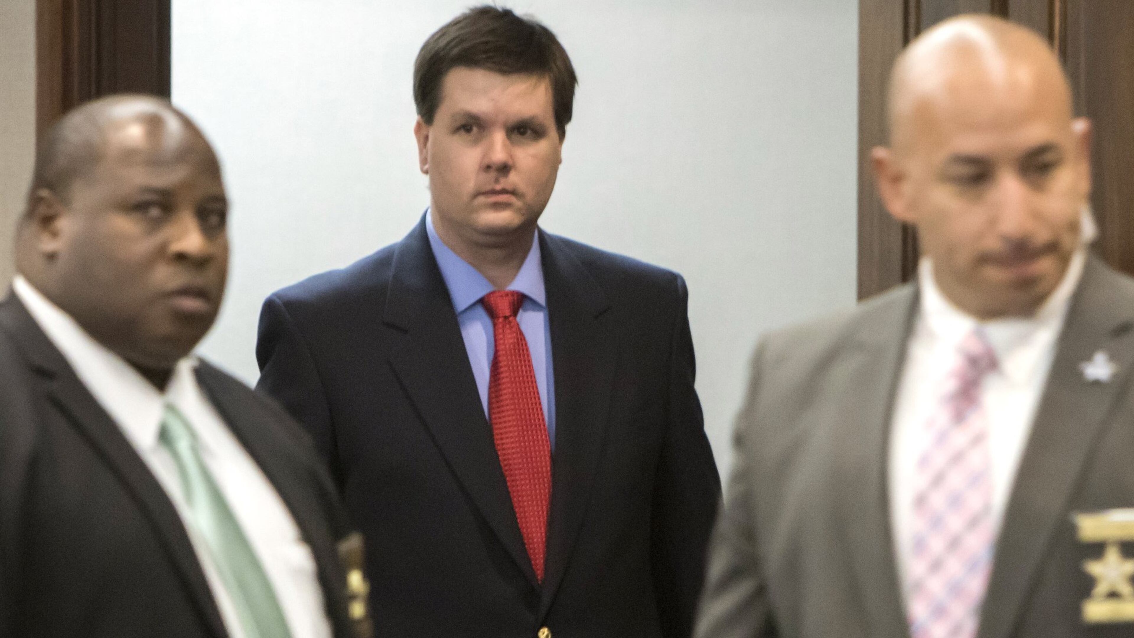 Ross Harris (center) walks into court flanked by sheriff’s deputies. (Stephen B. Morton for The Atlanta Journal Constitution)
