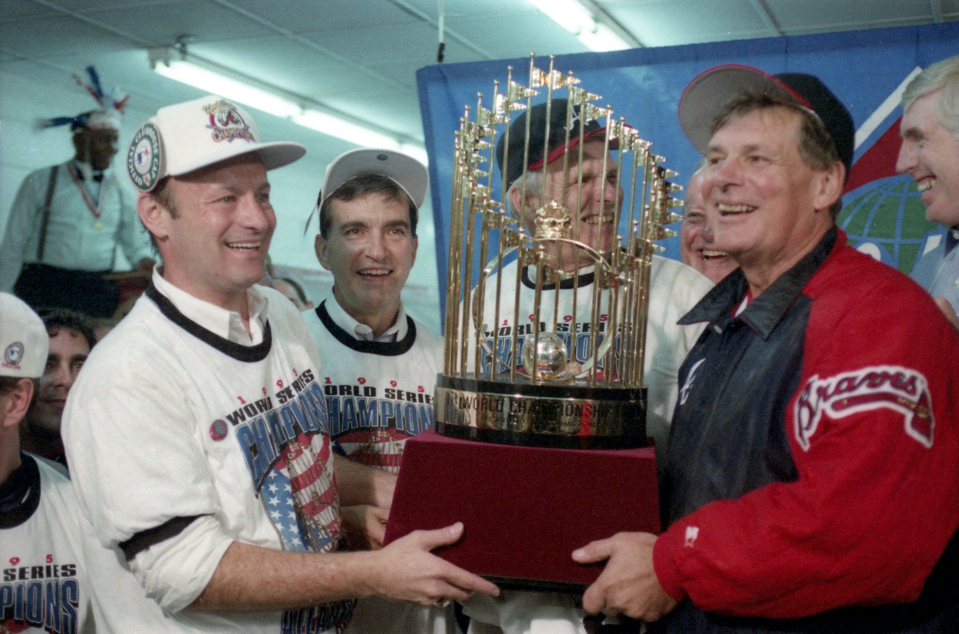 OCTOBER 28, 1995 ATLANTA Atlanta Braves manager Bobby Cox holding the World Series trophy with Ted Turner and team presidents after World Series Game Six, 1995 DAVID TULIS/AJC STAFF