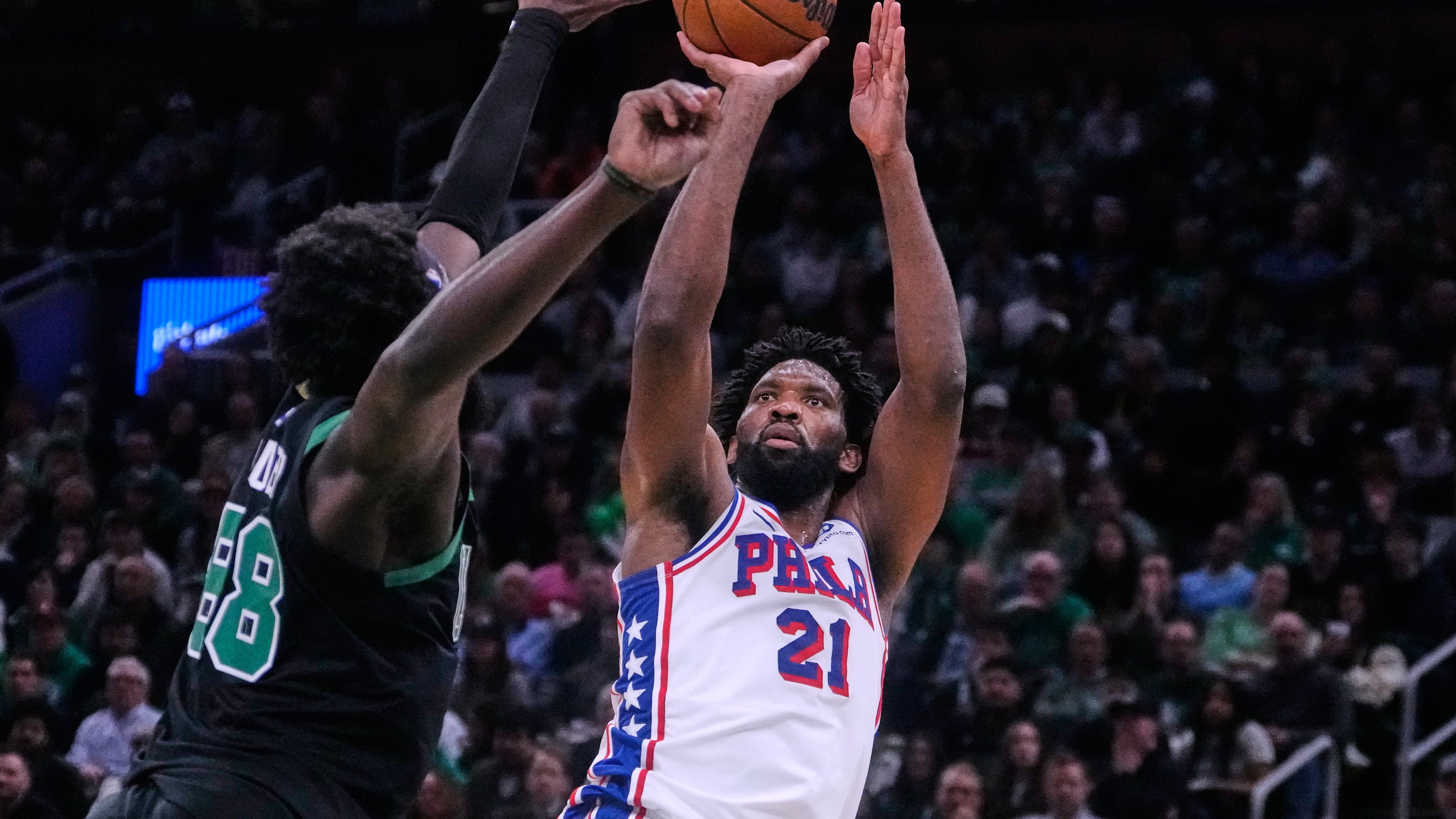Philadelphia 76ers center Joel Embiid (21) takes a shot over Boston Celtics center Neemias Queta (88) during the second half of Game 5 of a first-round NBA playoffs basketball series, Tuesday, April 28, 2026, in Boston. (AP Photo/Charles Krupa)