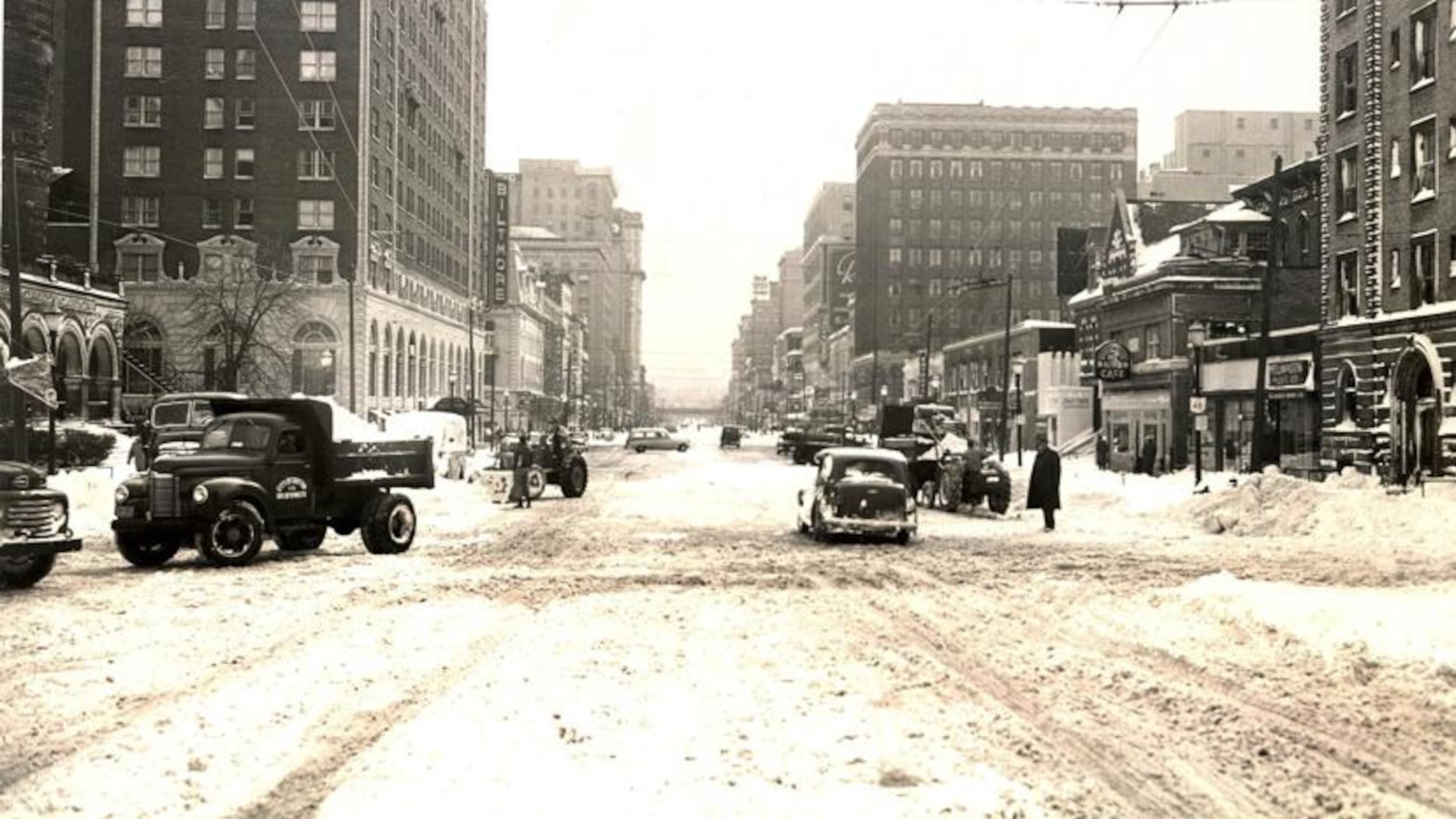 Vehicles and pedestrians attempt to navigate Main St. in downtown Dayton after nearly a foot of snow fell across the region after Thanksgiving Day in 1950