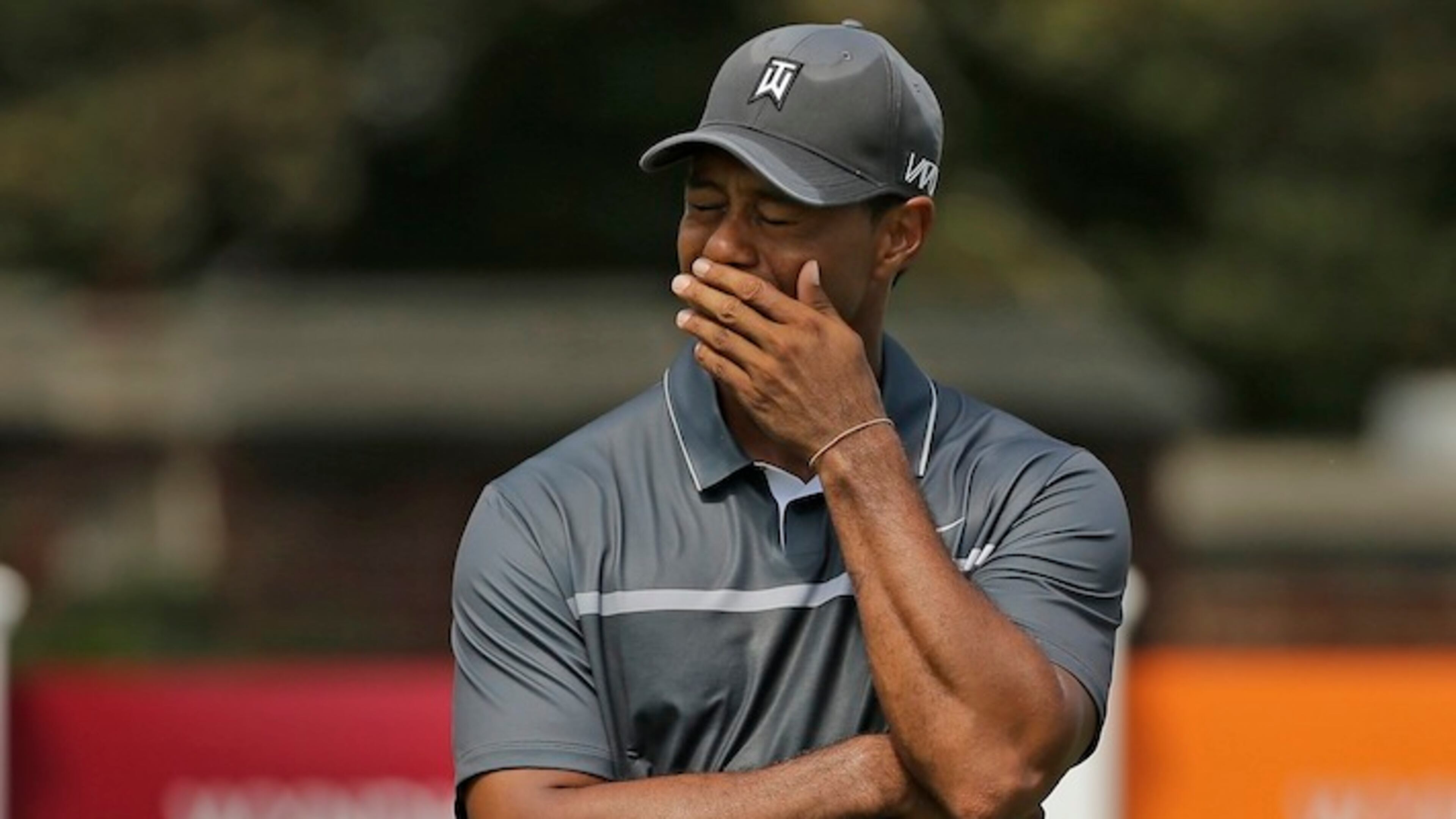 FILE - In this Aug. 21, 2015, file photo, Tiger Woods reacts after missing a putt on the ninth hole during the second round of the Wyndham Championship golf tournament in Greensboro, N.C. Tiger Woods painted a bleak picture Tuesday, Dec. 1, 2015, on when he can return to golf or even get back to doing anything more than just walking.(AP Photo/Chuck Burton)