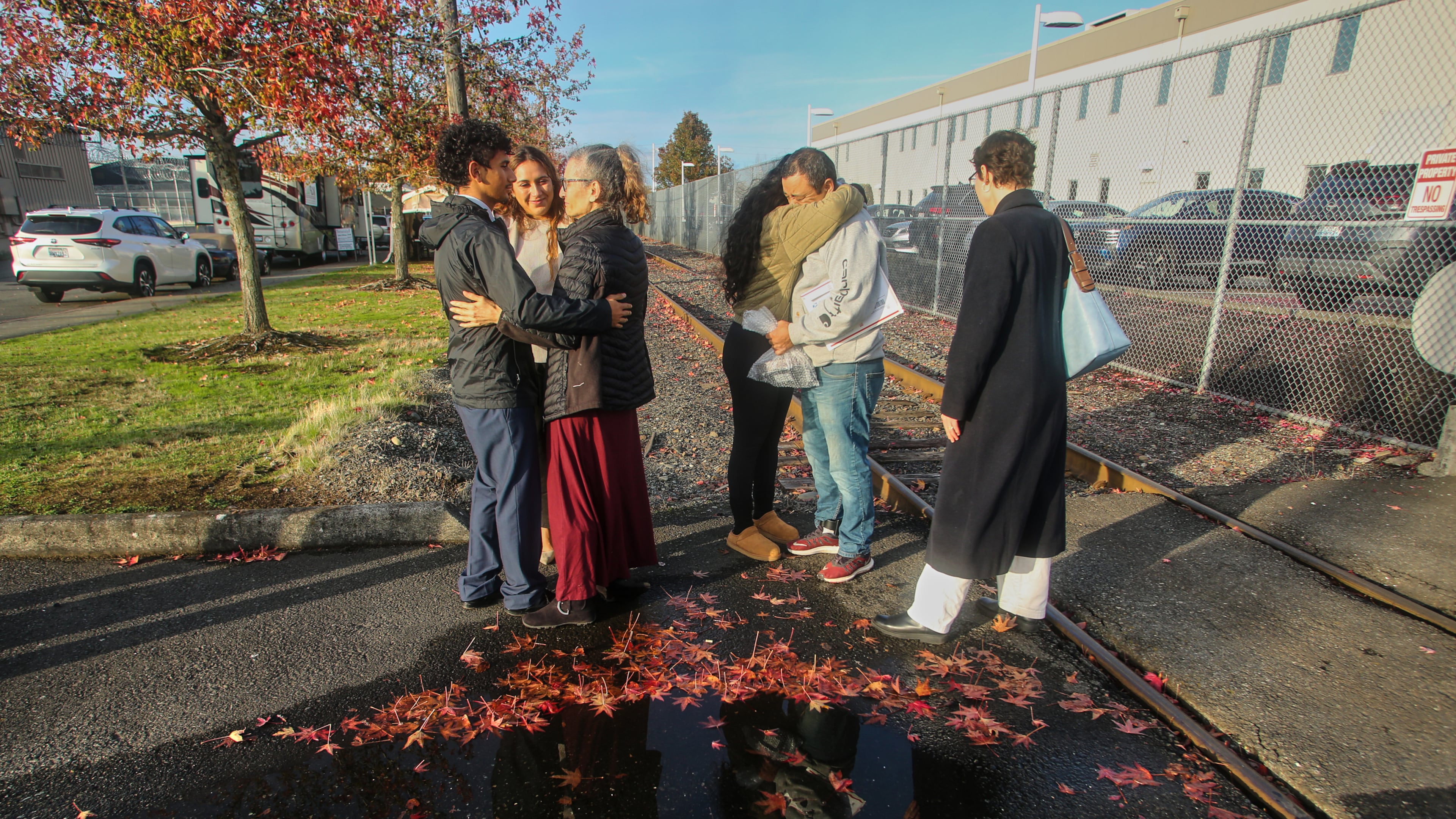Immigrants from Portland, including Victor Cruz, center right, in the gray hooded sweatshirt, embrace family members after being released on bond in Tacoma, Wash., Friday, Nov. 7, 2025. (AP Photo/Cedar Attanasio)