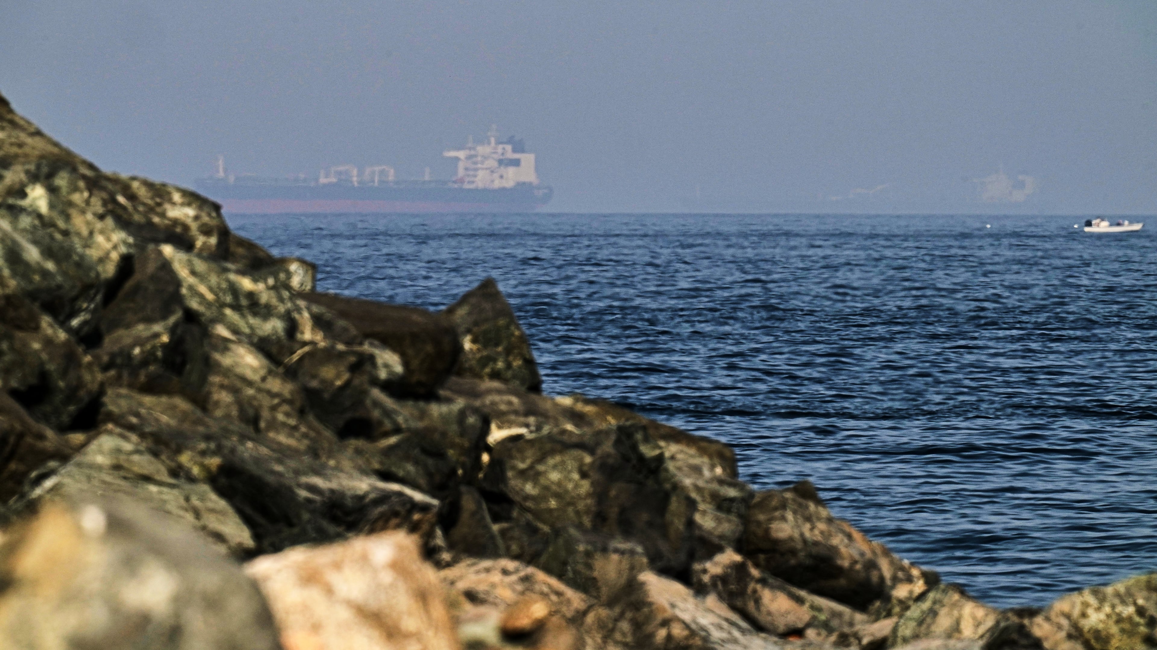 Cargo ships are seen at sea in the Gulf of Oman near the Strait of Hormuz, as viewed from a rocky shoreline near Khor Fakkan, United Arab Emirates, Friday, May 1, 2026.(AP Photo/Fatima Shbair)