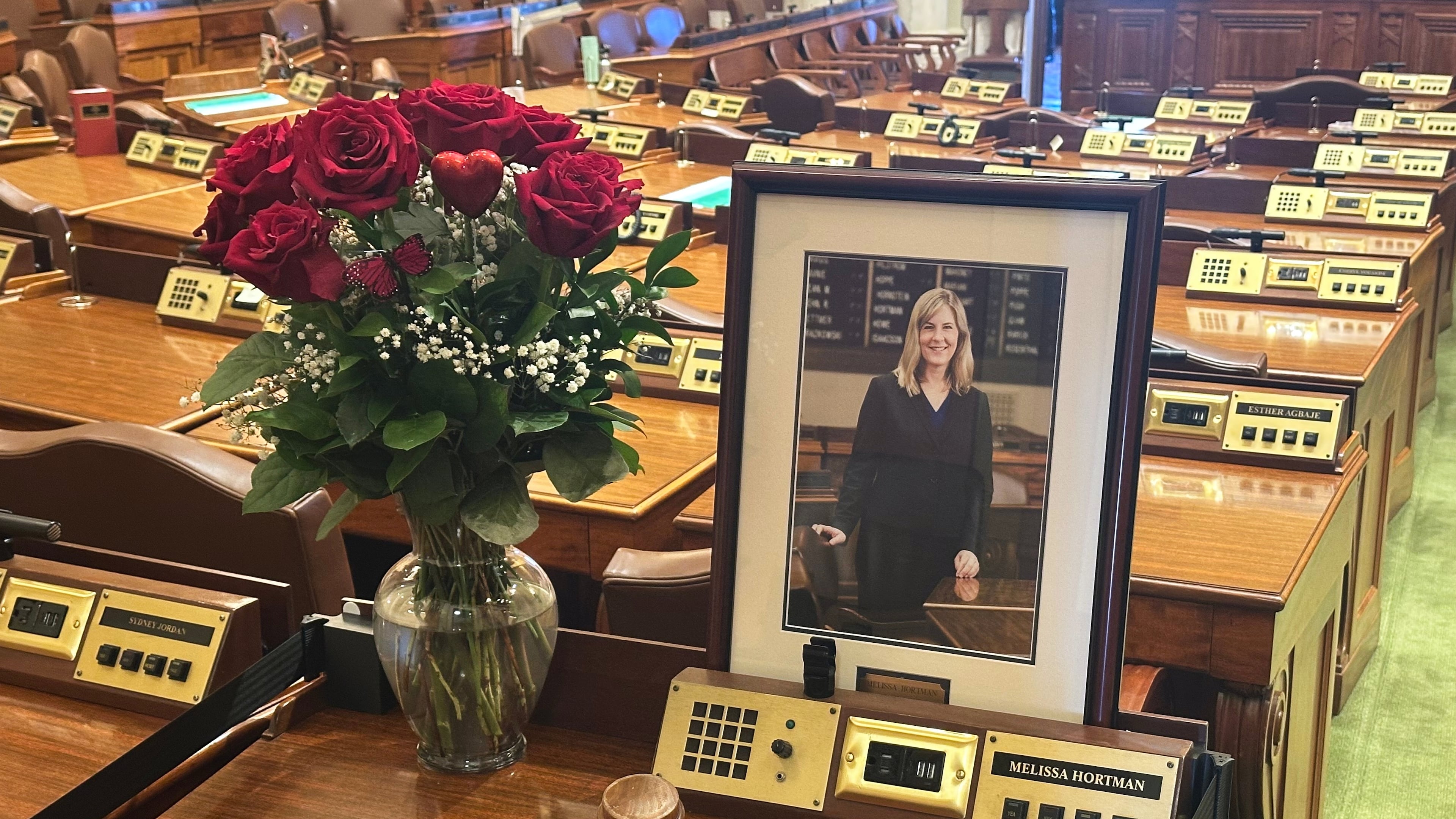 Former Minnesota House Speaker Melissa Hortman's desk sits empty in memoriam except for flowers, her portrait and a gavel in the Minnesota House chamber Wednesday, March 18, 2026, at the State Capitol in St. Paul, Minn. (AP Photo/Steve Karnowski)