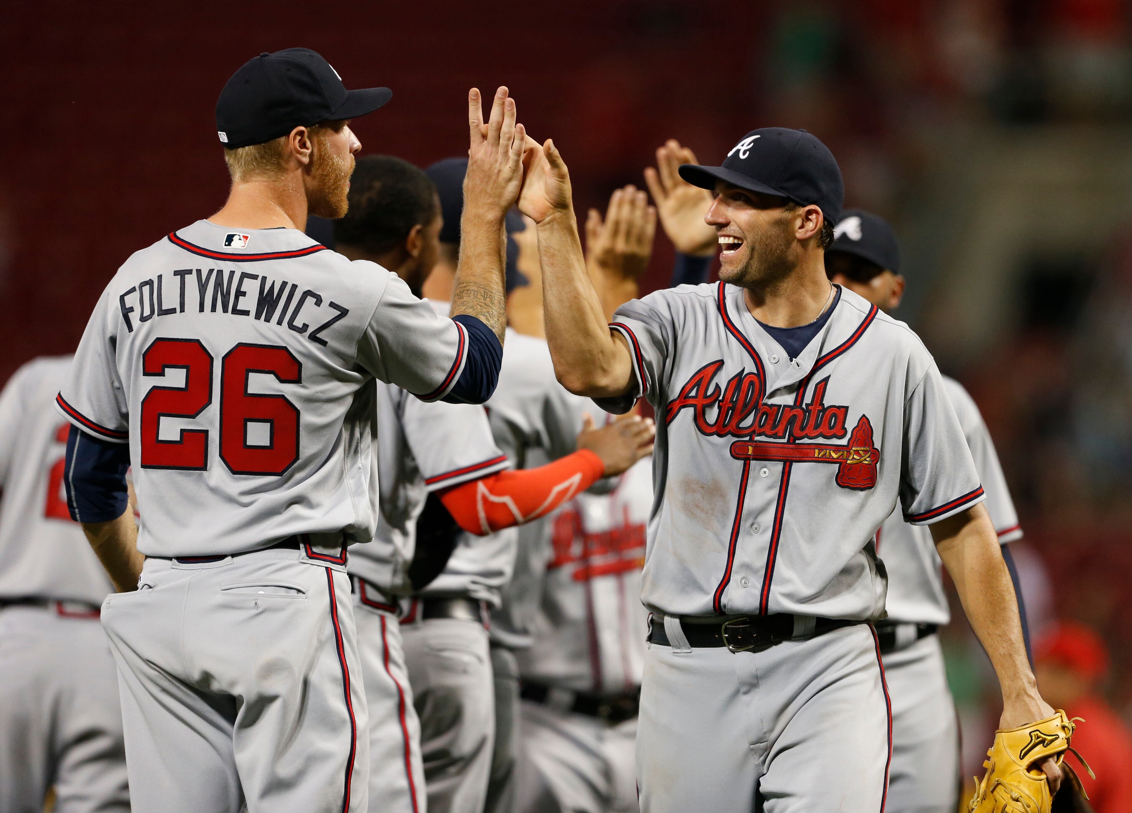 Atlanta Braves' Jeff Francoeur, right, and Mike Foltynewicz (26) celebrate their 5-4 win over the Cincinnati Reds in a baseball game, Tuesday, July 19, 2016, in Cincinnati. (AP Photo/Gary Landers)
