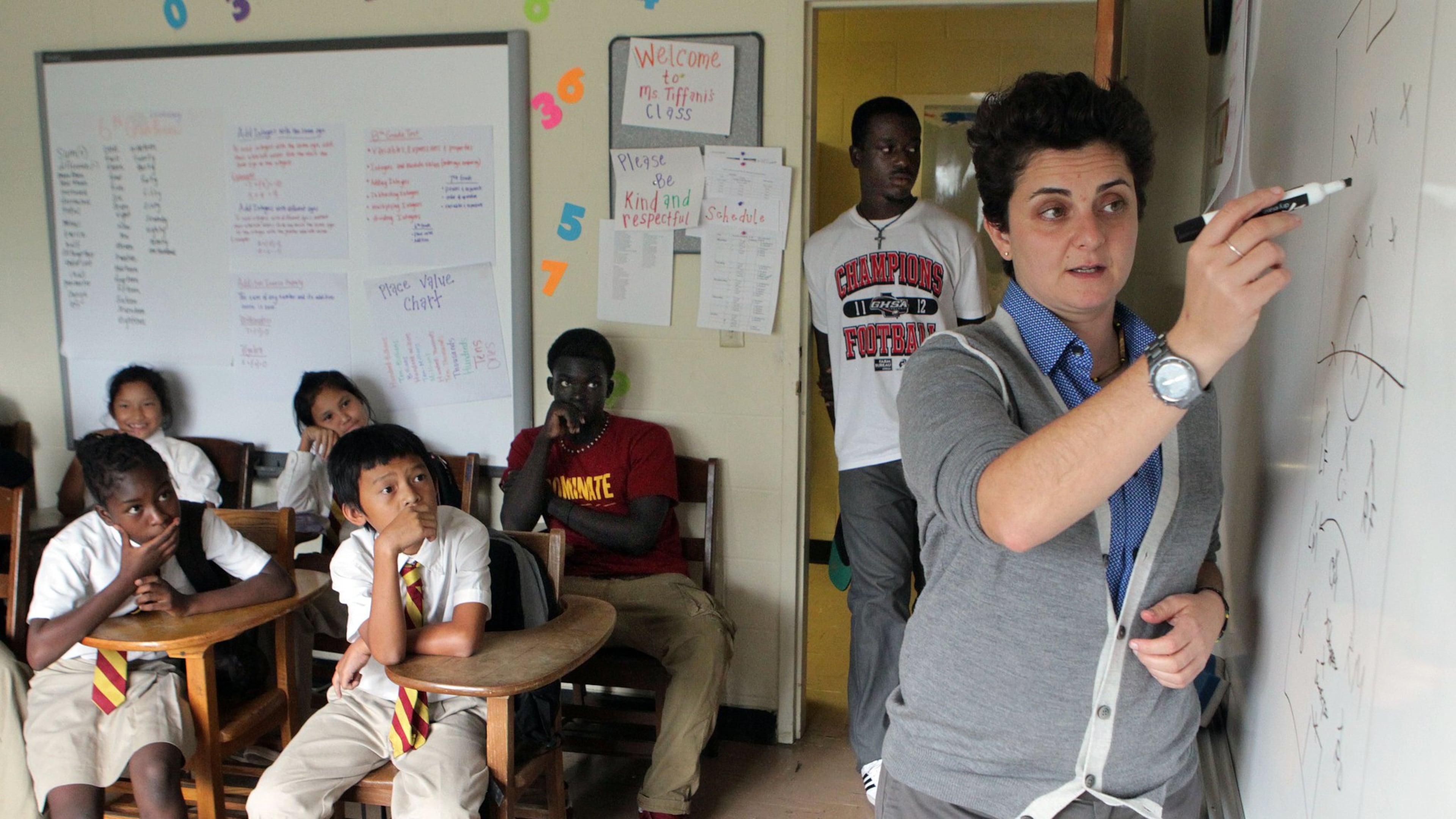 Students pay close attention as Luma Mufleh talks during a team meeting in Clarkston in the fall of 2012. When Mufleh first moved to Atlanta, she says she was “lost,” unsure what to do with her life. She was smart, recently graduated from Smith College. She was waiting tables, working in IT when she took a wrong turn and her life changed. Mufleh was recently named one of the top 10 CNN Heroes of 2016. AJC FILE PHOTO