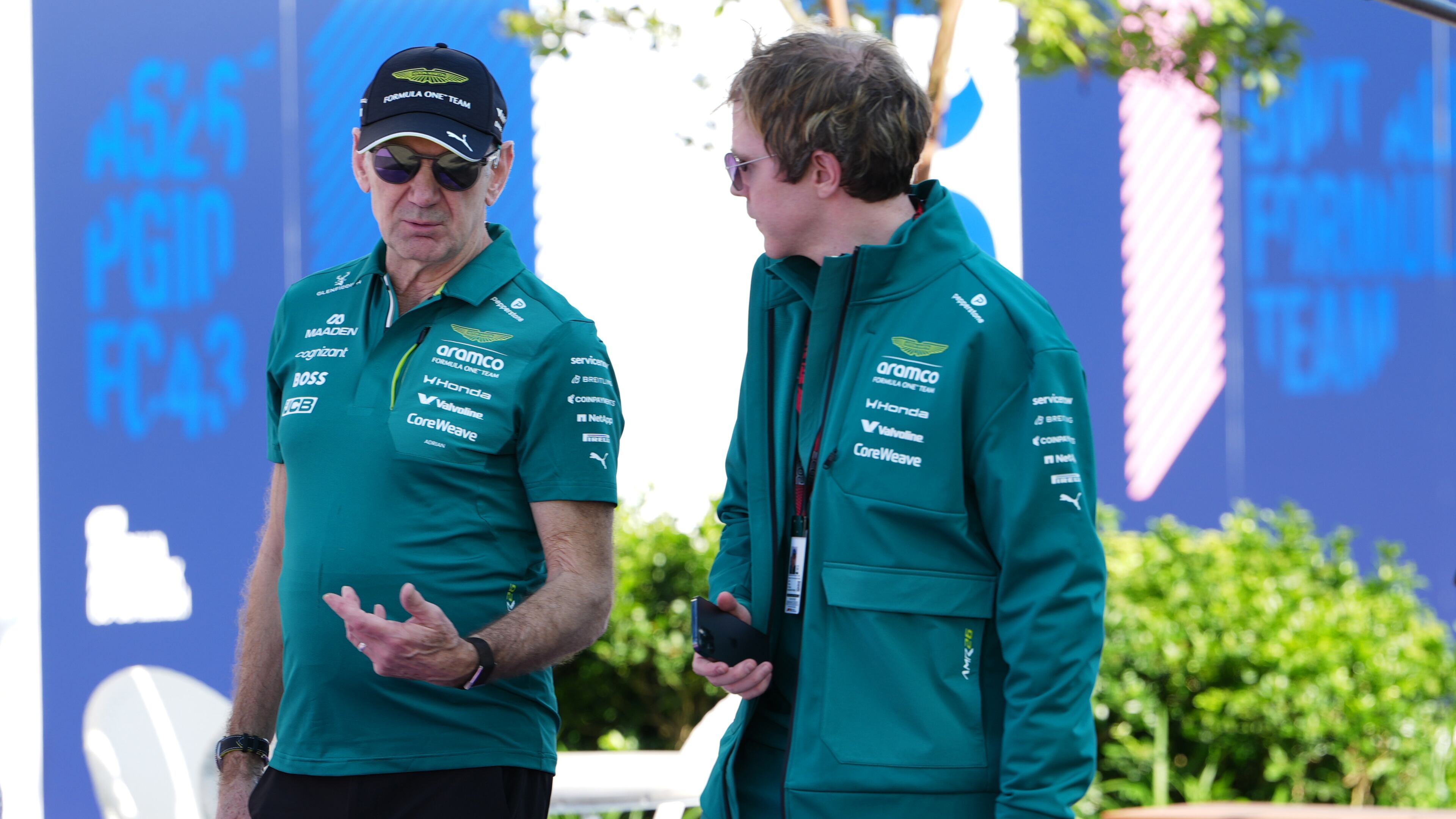 Aston Martin team principal Adrian Newey, left, talks with a team member as he arrives at the track ahead of the Australian Formula One Grand Prix at Albert Park, in Melbourne, Australia, Thursday, March 5, 2026. (AP Photo/Asanka Brendon Ratnayake)