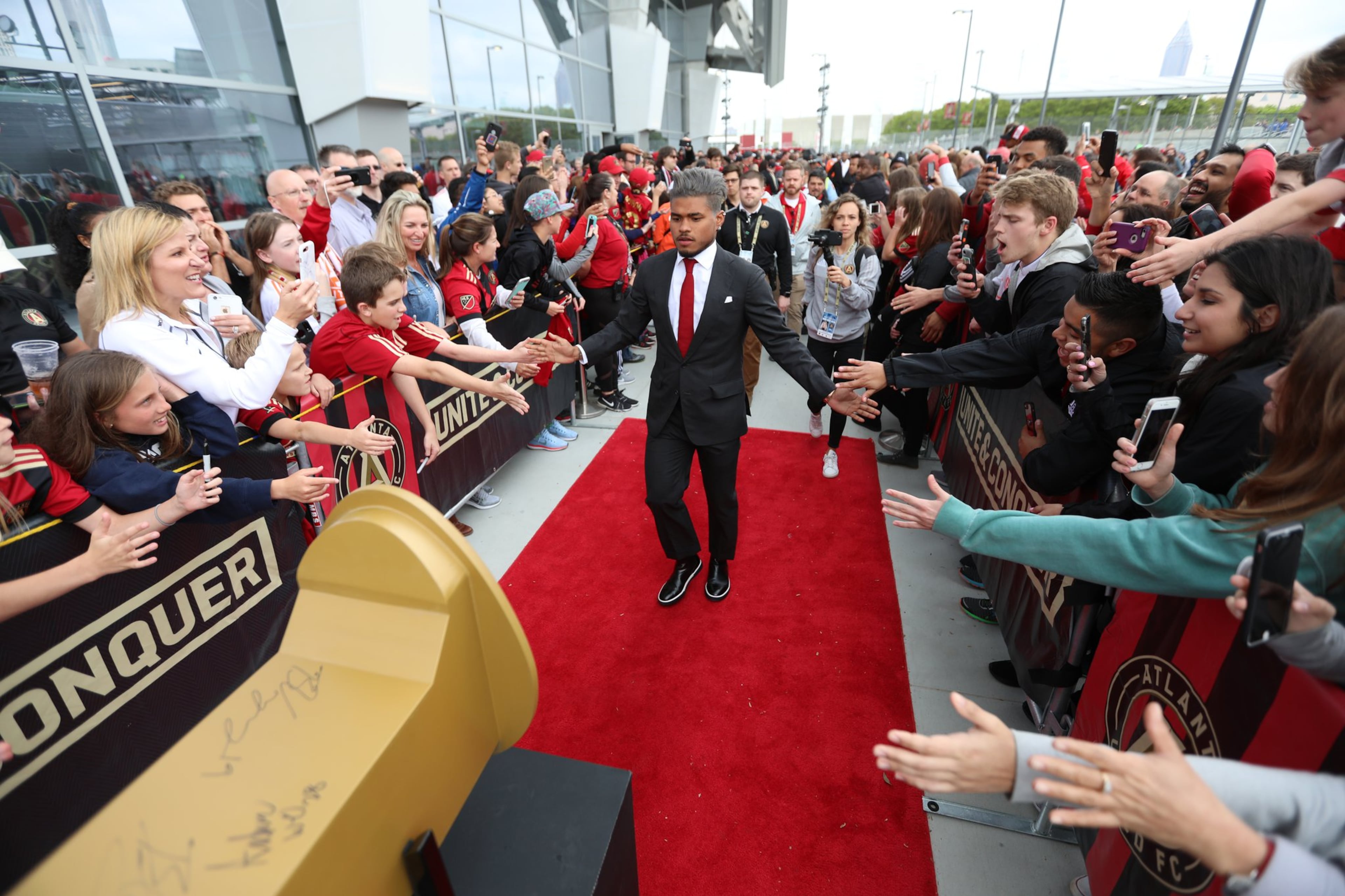 Josef Martinez greets fans as he approaches the giant golden spike outside Mercedes-Benz Stadium on April 7, 2018.