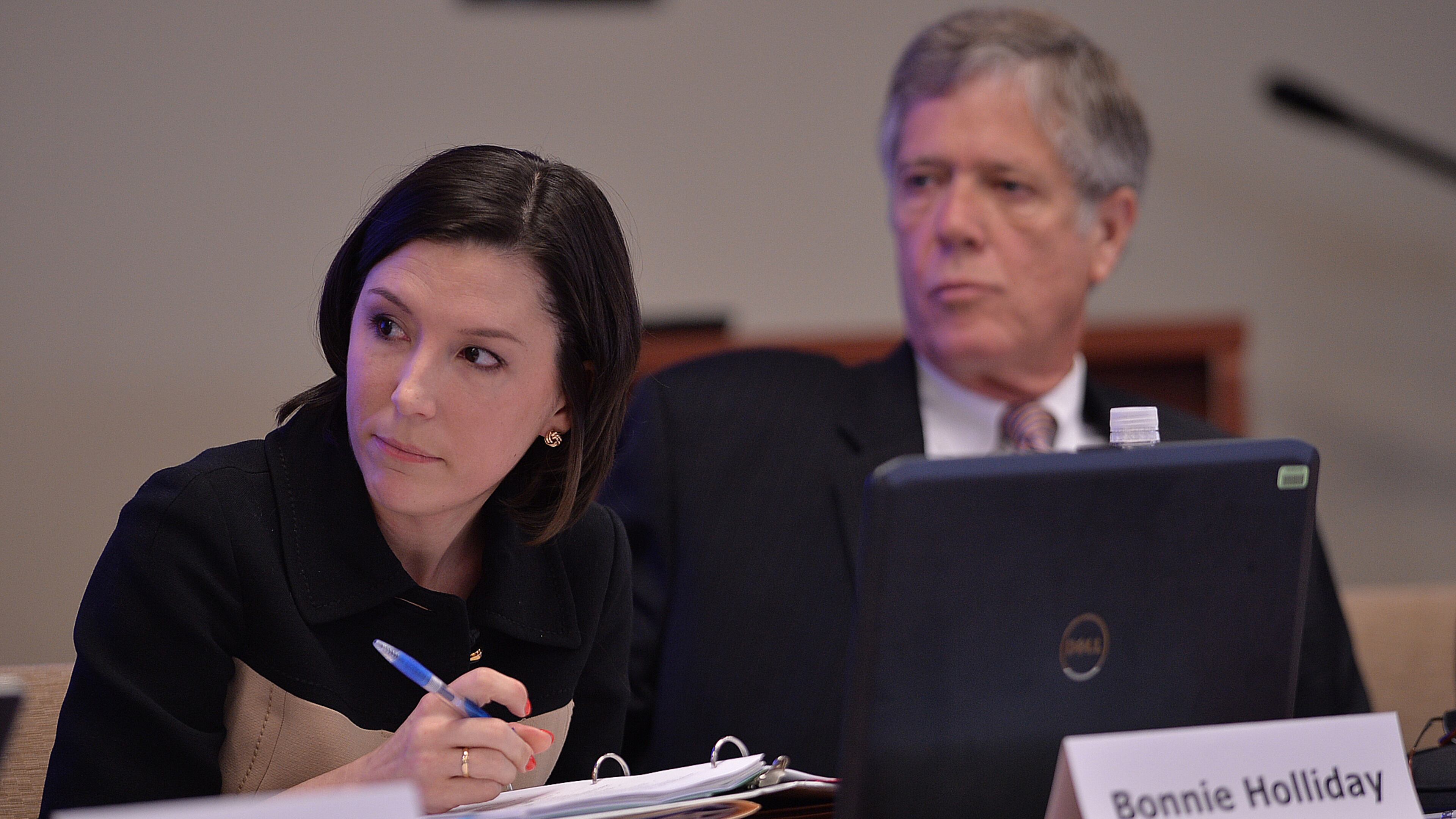 Bonnie Holliday, Executive Director of the State Charter Schools Commission of Georgia, and Tom Lewis listen to Chairman Dr. Charles Knapp during the State Charter Schools Commission meeting on Wednesday, May 29, 2013.