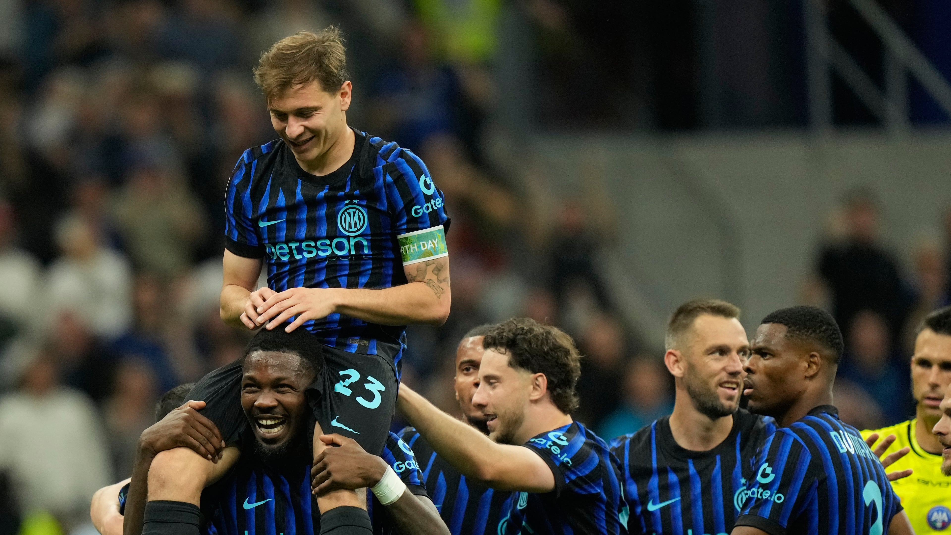 Inter Milan's Nicolo Barella, on Marcus Thuram shoulders, celebrates after scoring his side's 2nd goal during the Serie A soccer match between Inter Milan and Cagliari in Milan, Italy, Friday, April 17, 2026. (AP Photo/Luca Bruno)