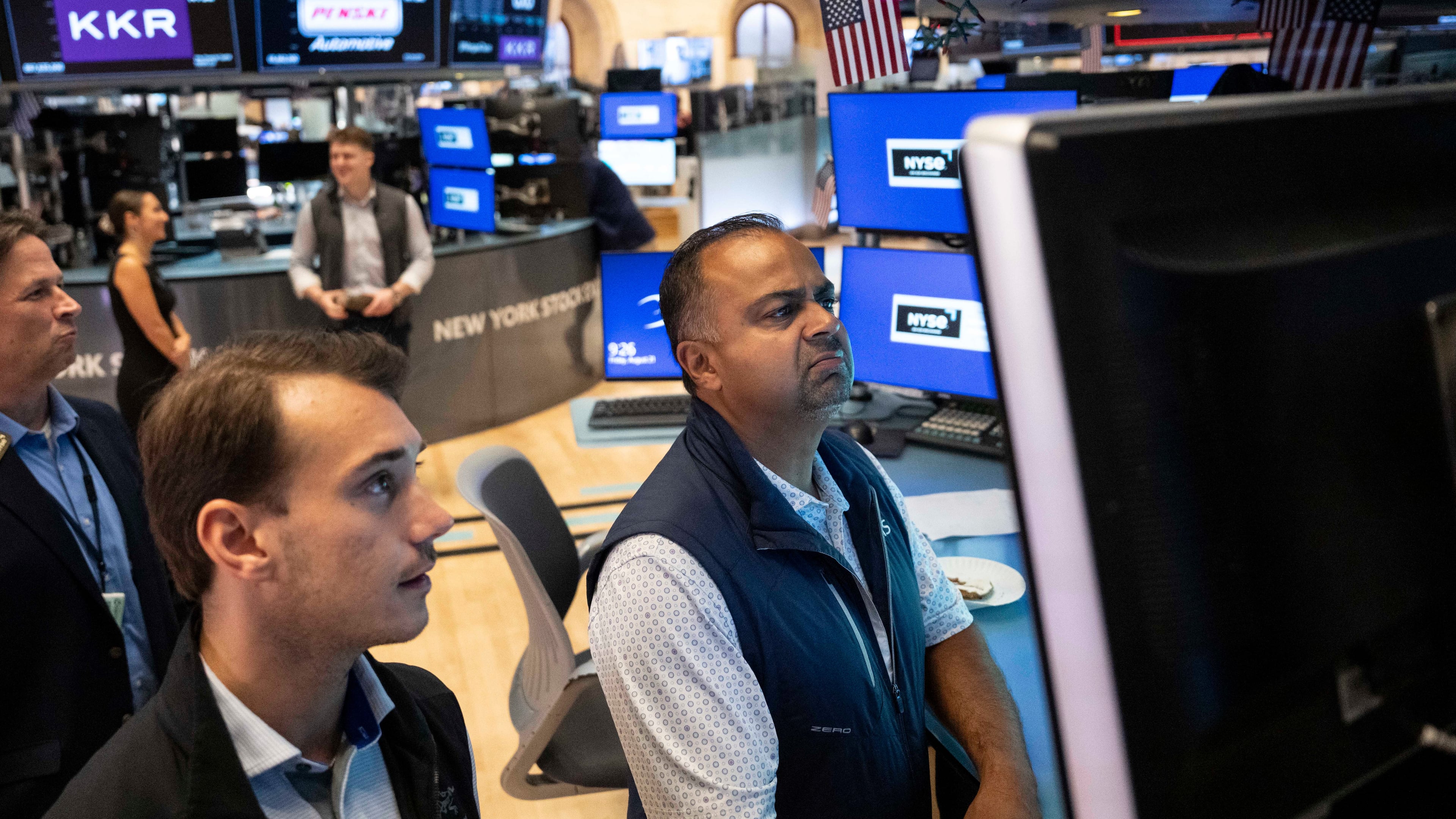 Specialists Dilip Patel, right, and Dylan Halvorsen work on the floor of the New York Stock Exchange in New York, Friday, Aug. 21, 2026. (AP Photo/Yuki Iwamura)