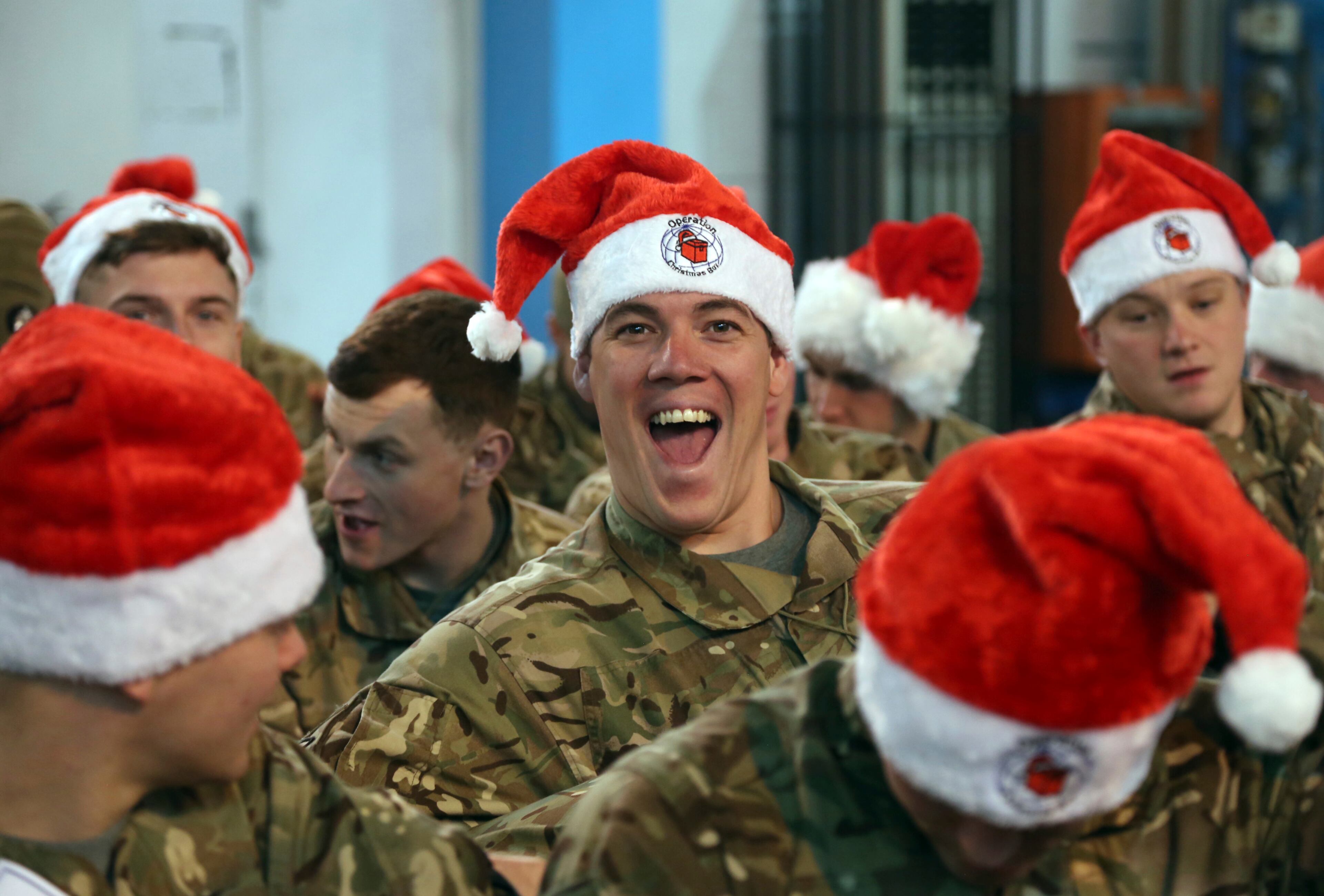 A soldier poses for a photograph during a ceremony on Christmas Day at the Resolute Support Headquarters, in Kabul, Afghanistan, Tuesday, Dec. 25, 2018. (AP Photo/Rahmat Gul)