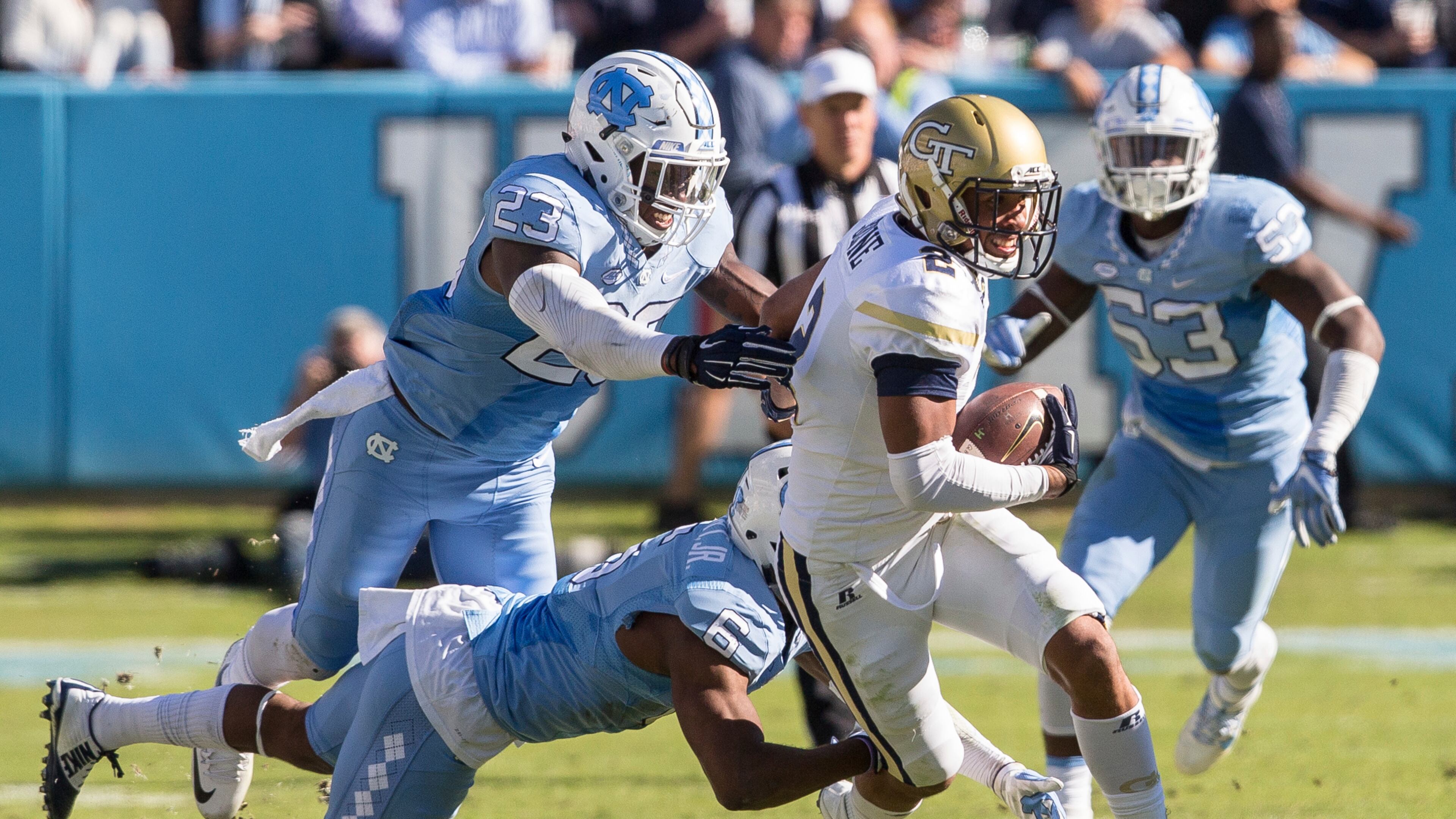 Georgia Tech’s Ricky Jeune (2) carries the ball as North Carolina’s M.J. Stewart (6) and Caryson Collins (23) reach for a tackle during the second half of an NCAA college football game in Chapel Hill, N.C., Saturday, Nov. 5, 2016. North Carolina beat Georgia Tech 48-20. (AP Photo/Ben McKeown)