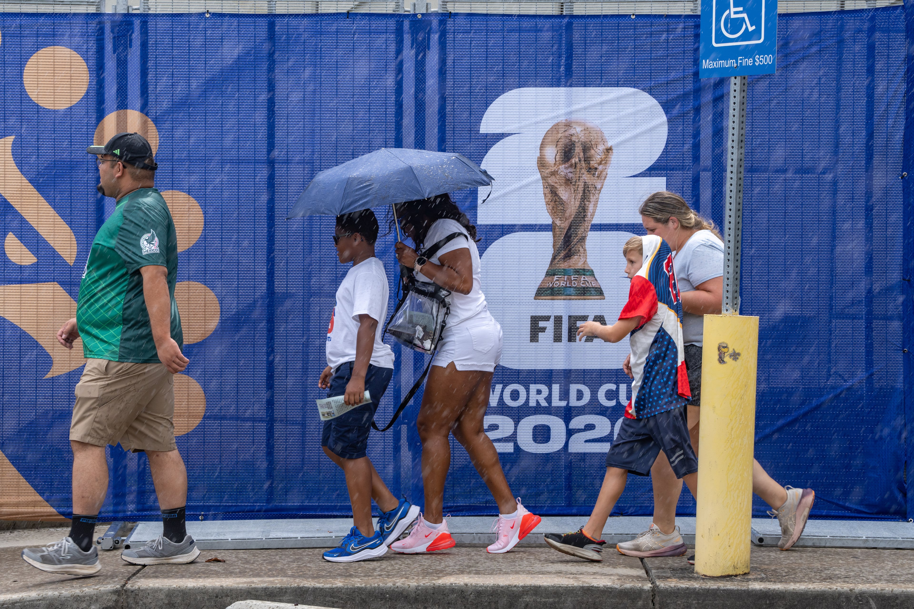Soccer fans walk in the rain to Atlanta Stadium for the South Africa vs. Czechia match on Thursday, June 18, 2026. (Ben Hendren for the AJC)