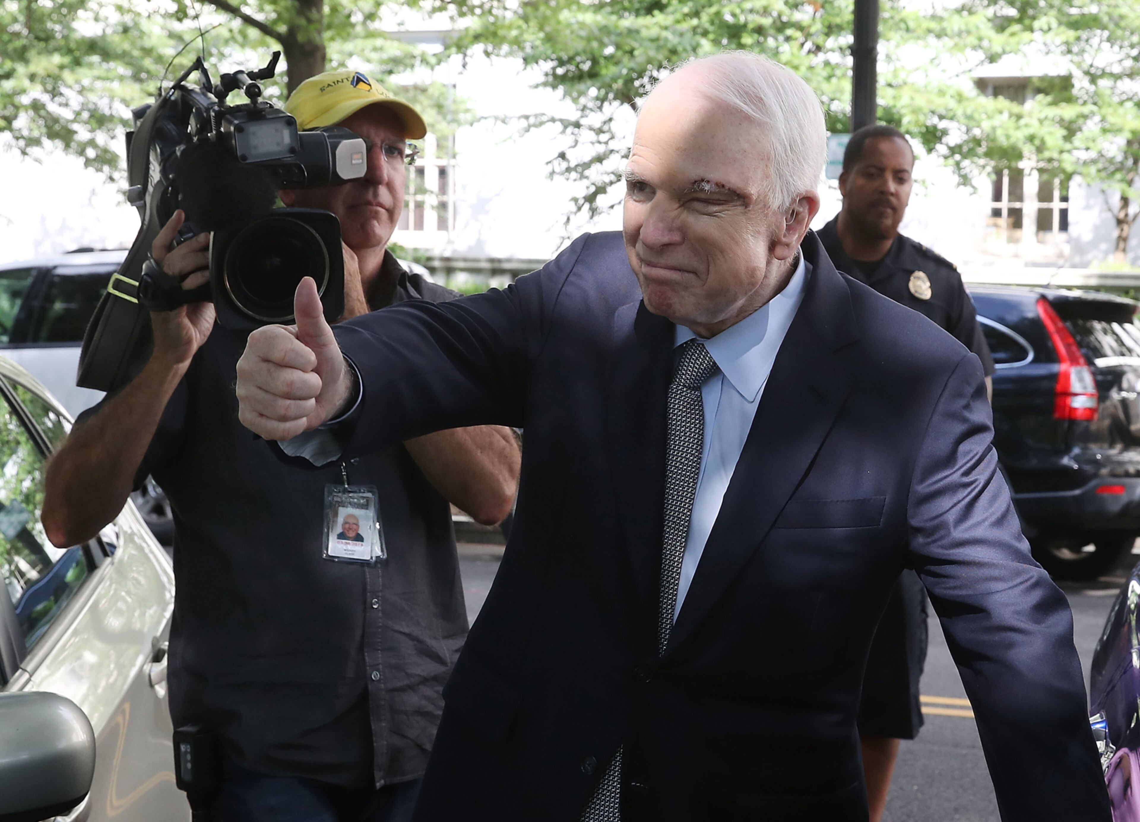 WASHINGTON, DC - JULY 25: Sen. John McCain (R-AZ) gives a thumbs up to well wishers as he gets into his car at the US Capitol July 25, 2017 in Washington, DC. McCain was recently diagnosed with brain cancer but returned on the day the Senate is holding a key procedural vote on U.S. President Donald Trump's effort to repeal and replace the Affordable Care Act. (Photo by Mark Wilson/Getty Images)
