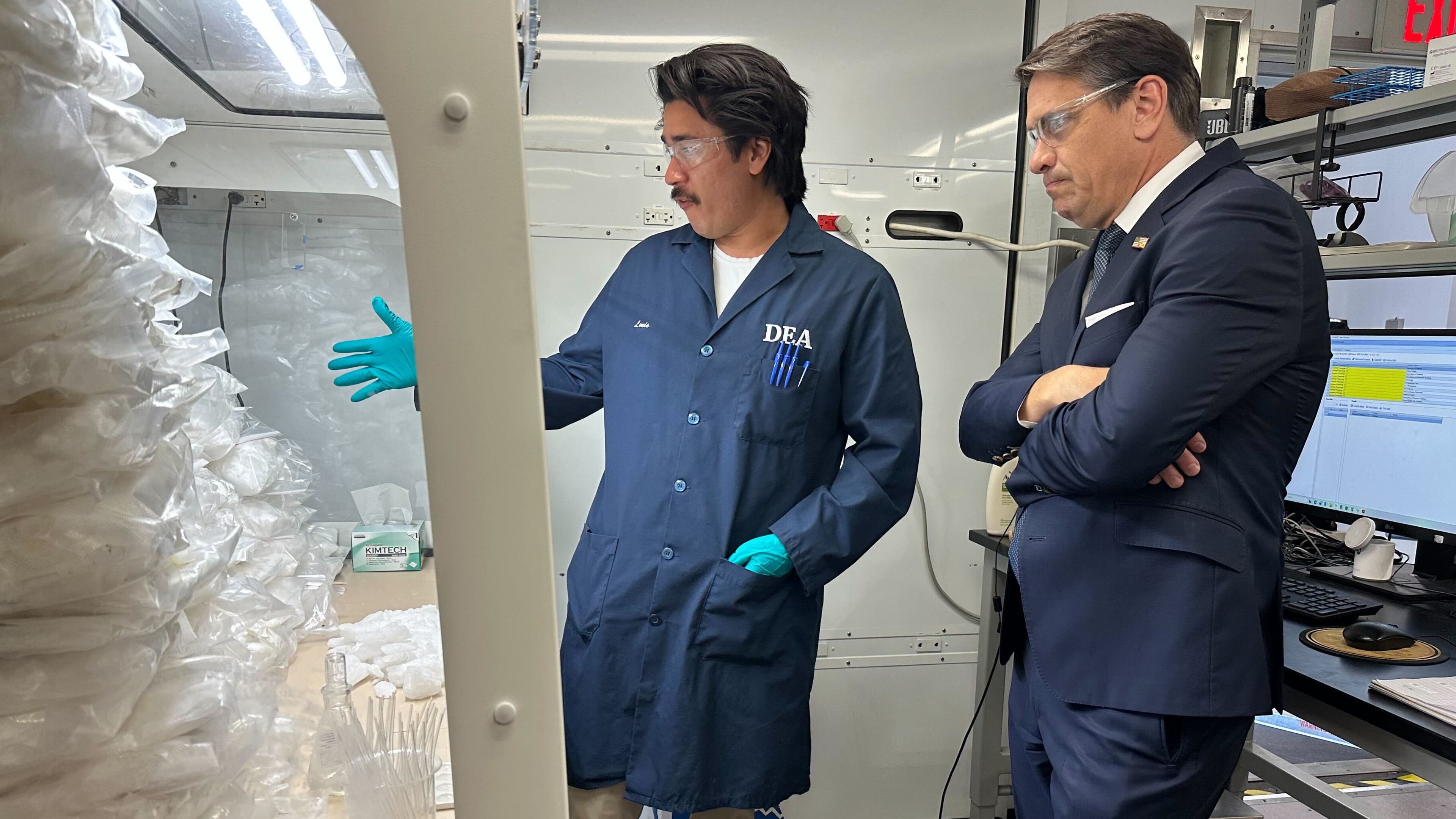 Acting Attorney General Todd Blanche talks to a technician in a Drug Enforcement Administration (DEA) mobile lab who is running tests on seized drugs in Phoenix, Wednesday, May 6, 2026. (AP Photo/Rebecca Santana)