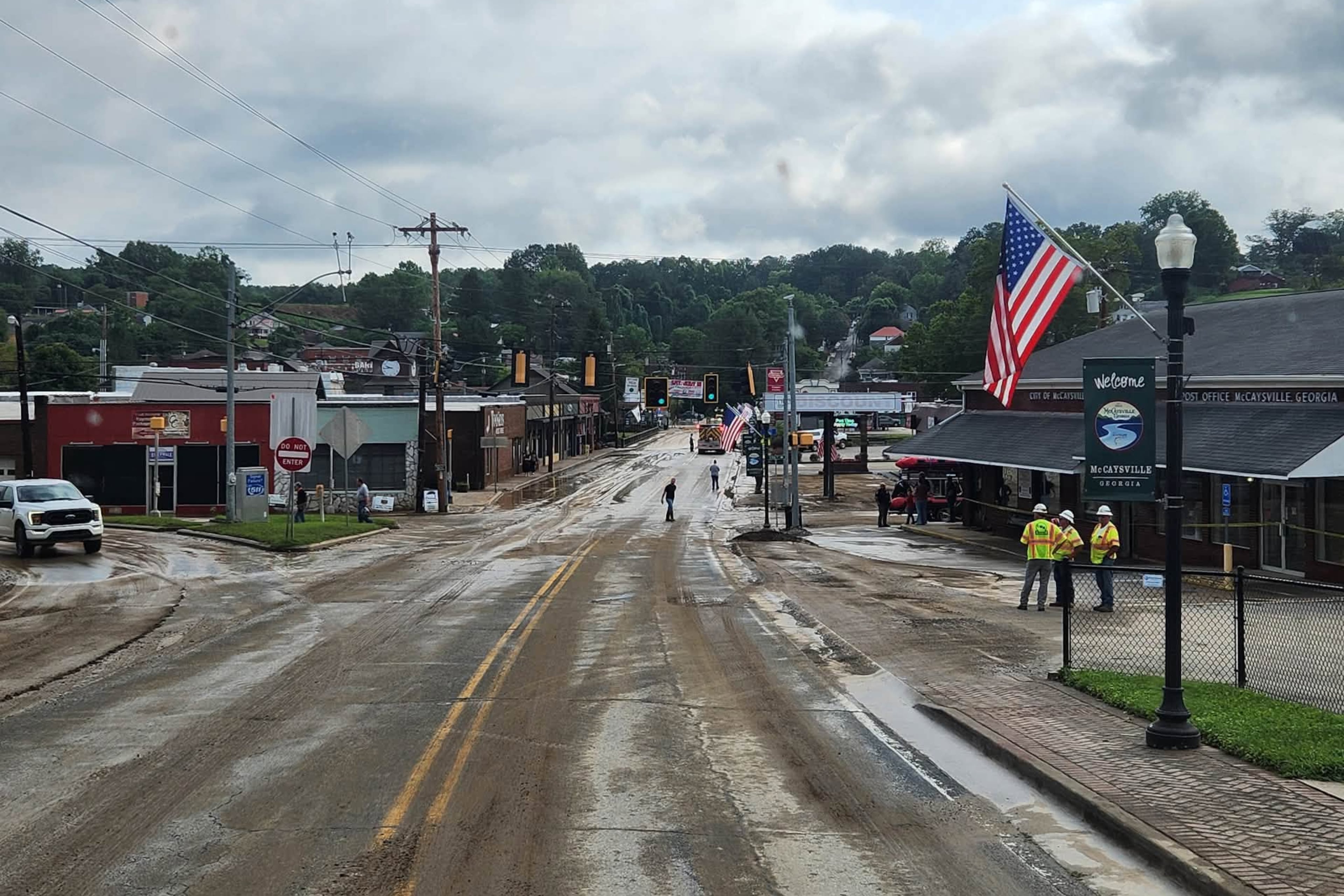 City and county crews and residents in McCaysville clean up streets and repair roads and buildings on Sunday, Aug. 2, 2026, after heavy rainfall overnight led to flooding in the North Georgia small town. (Courtesy of Fannin County Fire Department)