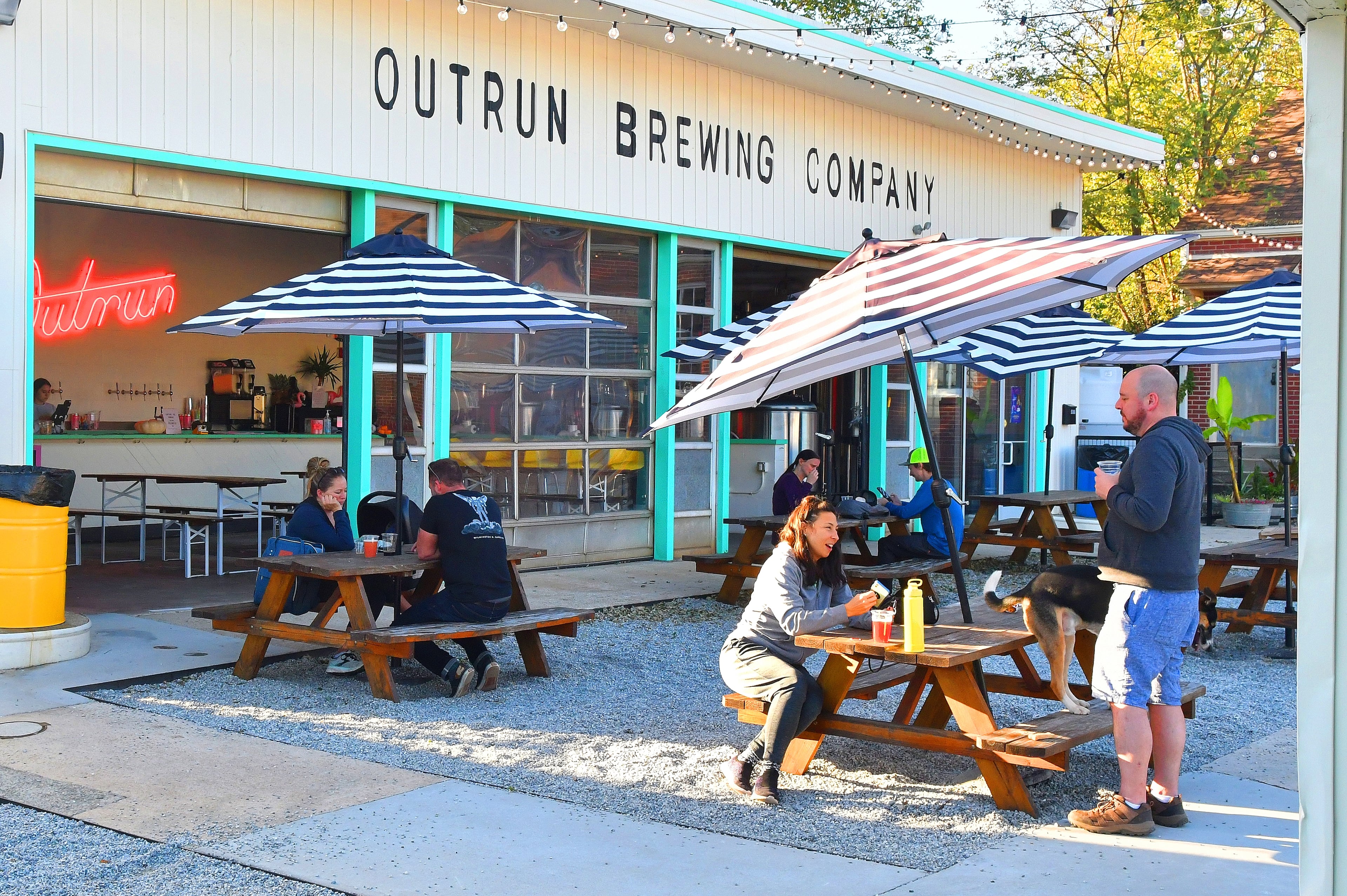 Patrons enjoy a cool late Sunday afternoon recently at Outrun Brewing Co. in Stone Mountain Village. (Chris Hunt for The Atlanta Journal-Constitution)