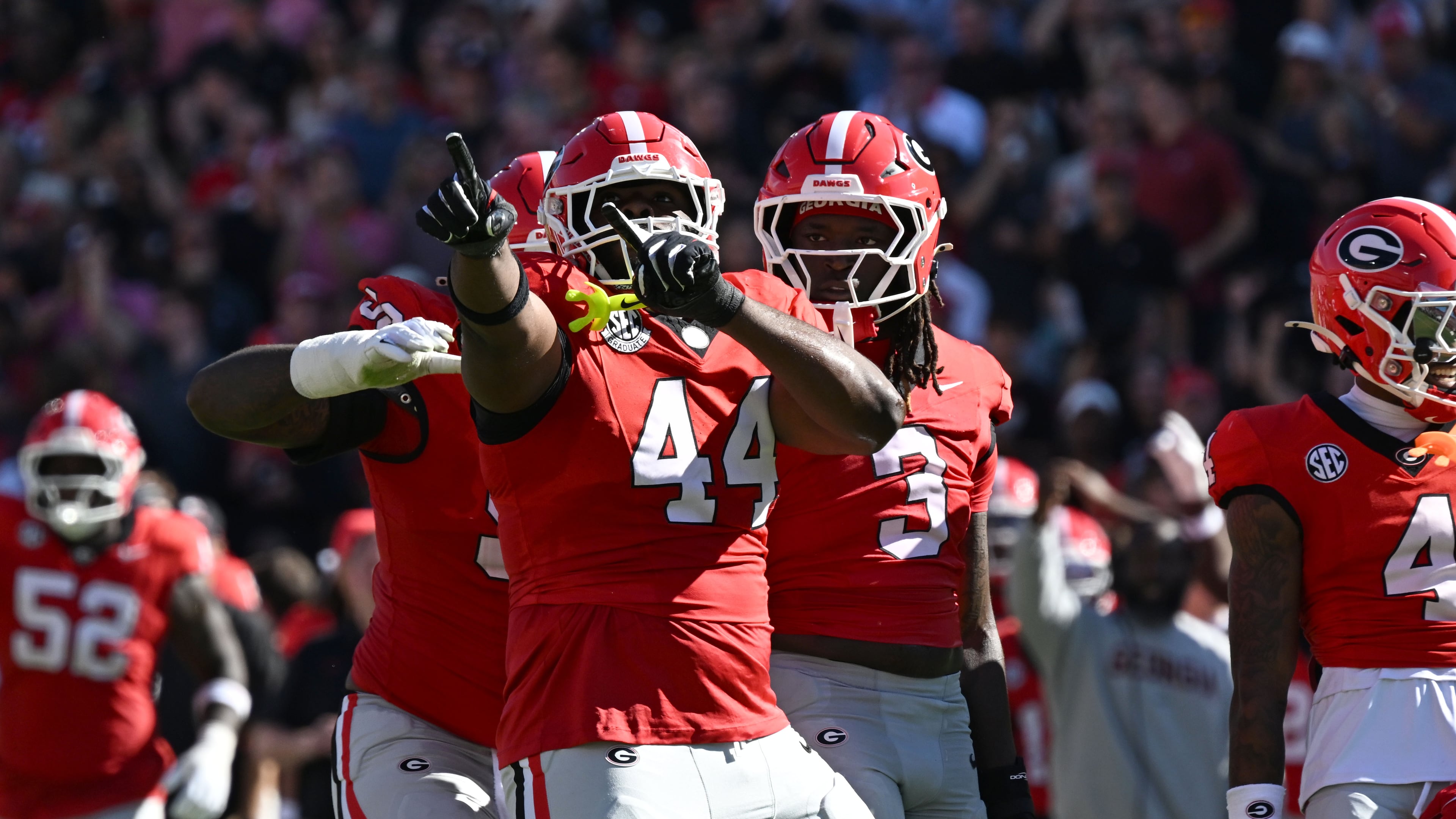 Georgia defensive lineman Jordan Hall (center) celebrates after he sacked Oklahoma quarterback John Mateer during the first half in an NCAA football game at Sanford Stadium on Saturday, Sept. 26, 2026, in Athens. (Hyosub Shin/AJC)