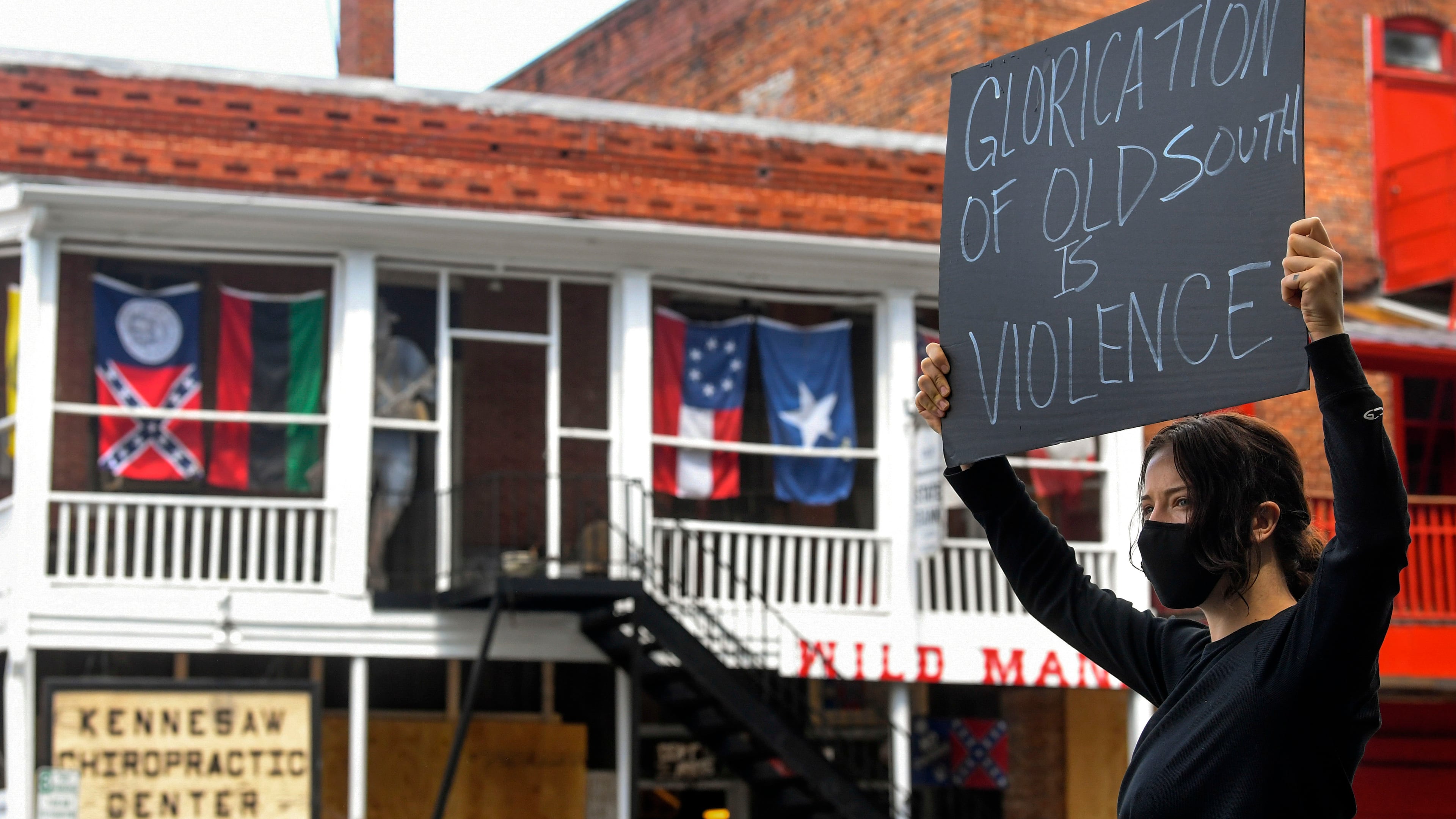 Chelsea Shag demonstrates across the street from a Confederate-era memorabilia shop, during a protest held Friday, June 5, 2020, in Kennesaw. Protests around the nation are occuring to sound off against the killing of George Floyd in Minneapolis police custody. JOHN AMIS FOR THE ATLANTA JOURNAL-CONSTITUTION