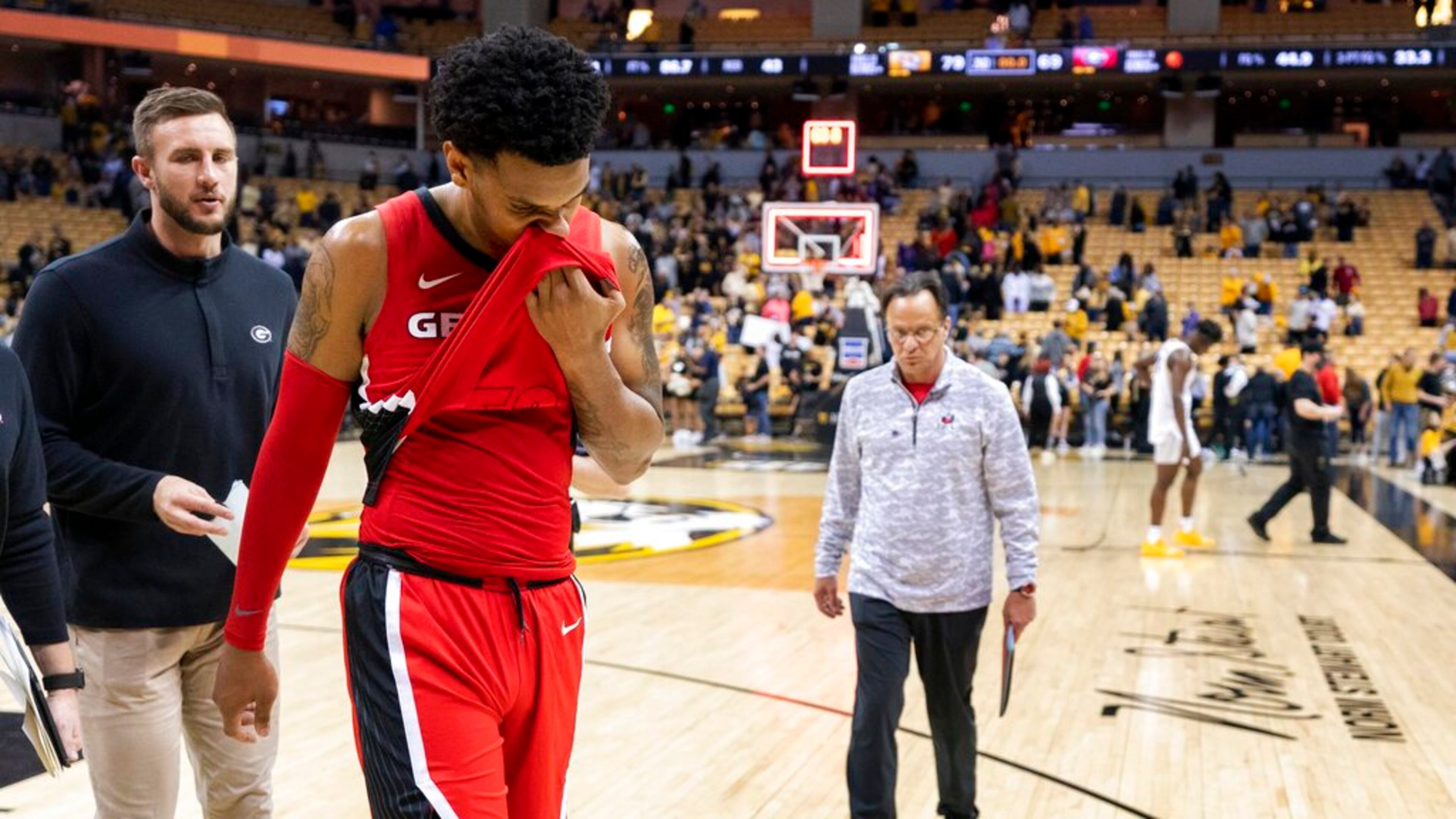 Georgia's Braelen Bridges wipes his face as he walks off the court and coach Tom Crean (right) follows after losing 79-69 to Missouri in an NCAA college basketball game Saturday, March 5, 2022, in Columbia, Mo. (AP Photo/L.G. Patterson)