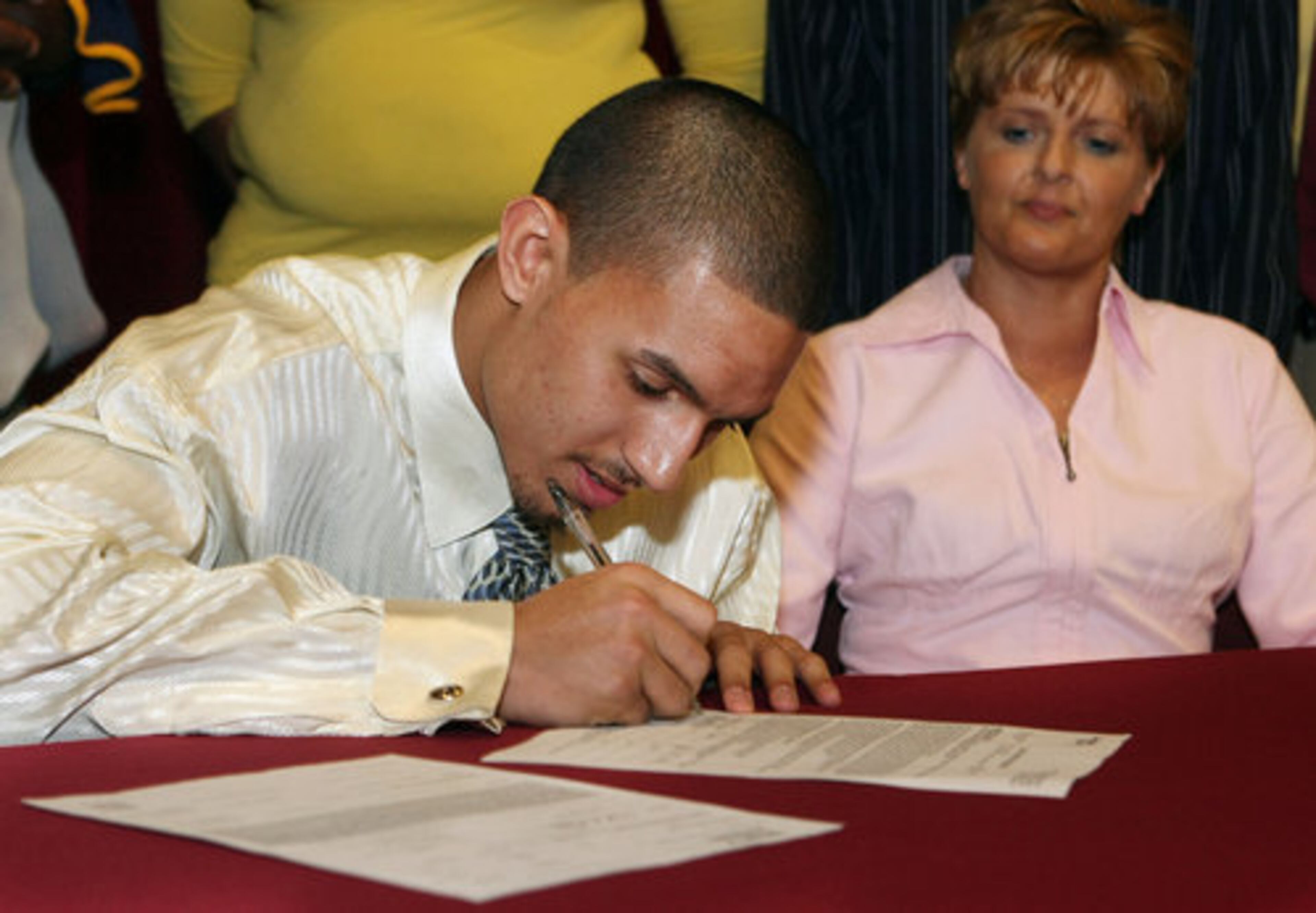 Ryan Ayers signs a letter of intent to play for Georgia Tech as his mother Pamela Davis watches at South Paulding High School on Wednesday, February 3rd. The new school had five football players sign letters this day. Broderick Sellers signed for Savannah State, Zach Hemmila-University of West Georgia, Reggie Davis & Cody Hunt both signed Olivet Nazarene.