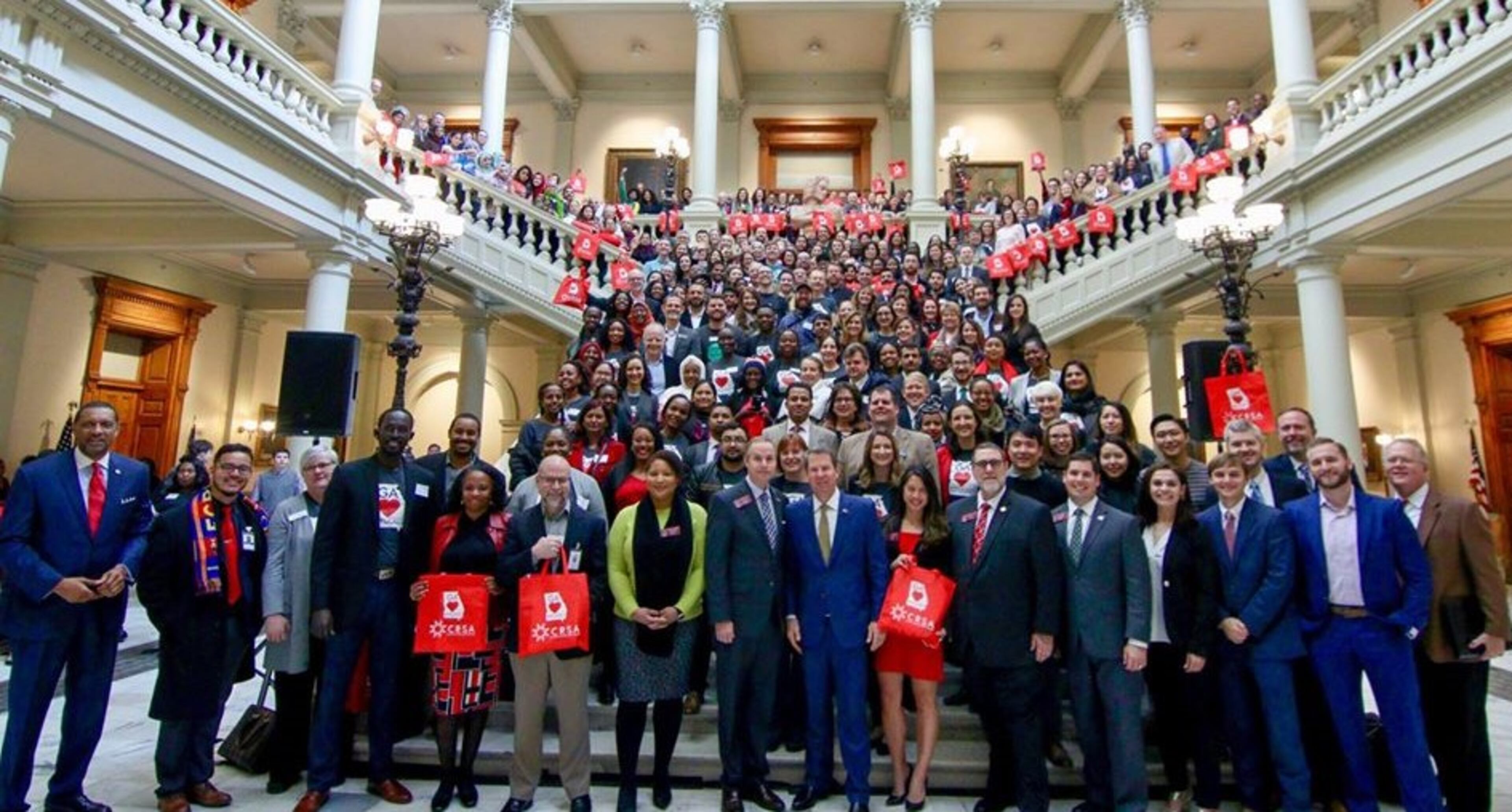 Gov. Brian Kemp posing with former refugees at a “new Americans” celebration at the state Capitol on Valentine’s Day last February. Photo by Joseph McBrayer for the Coalition of Refugee Service Agencies.