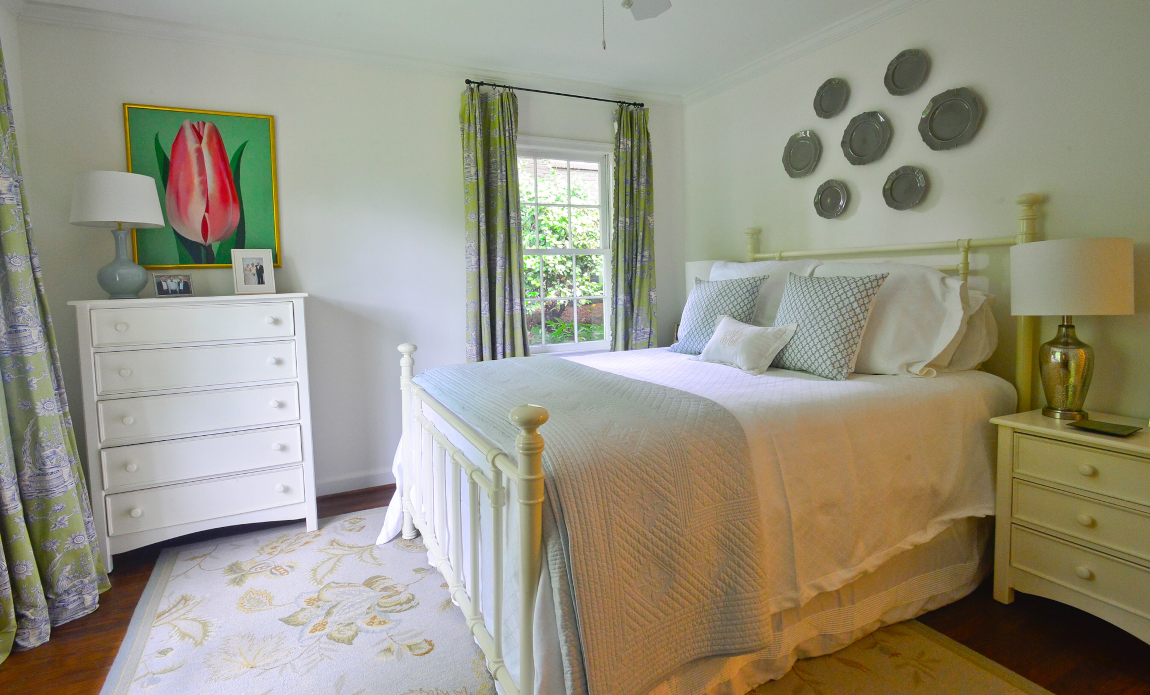 The tulip painting by Atlanta artist Comer Jennings adds a vibrant color to the bedroom and serves as a significant piece for the couple. Homeowner Catherine Callaway's family and the Jennings family were friends and neighbors for generations in Eufaula, Ala., where Catherine's mother and the artist grew up. The bed, tables and dresser are from Havertys.