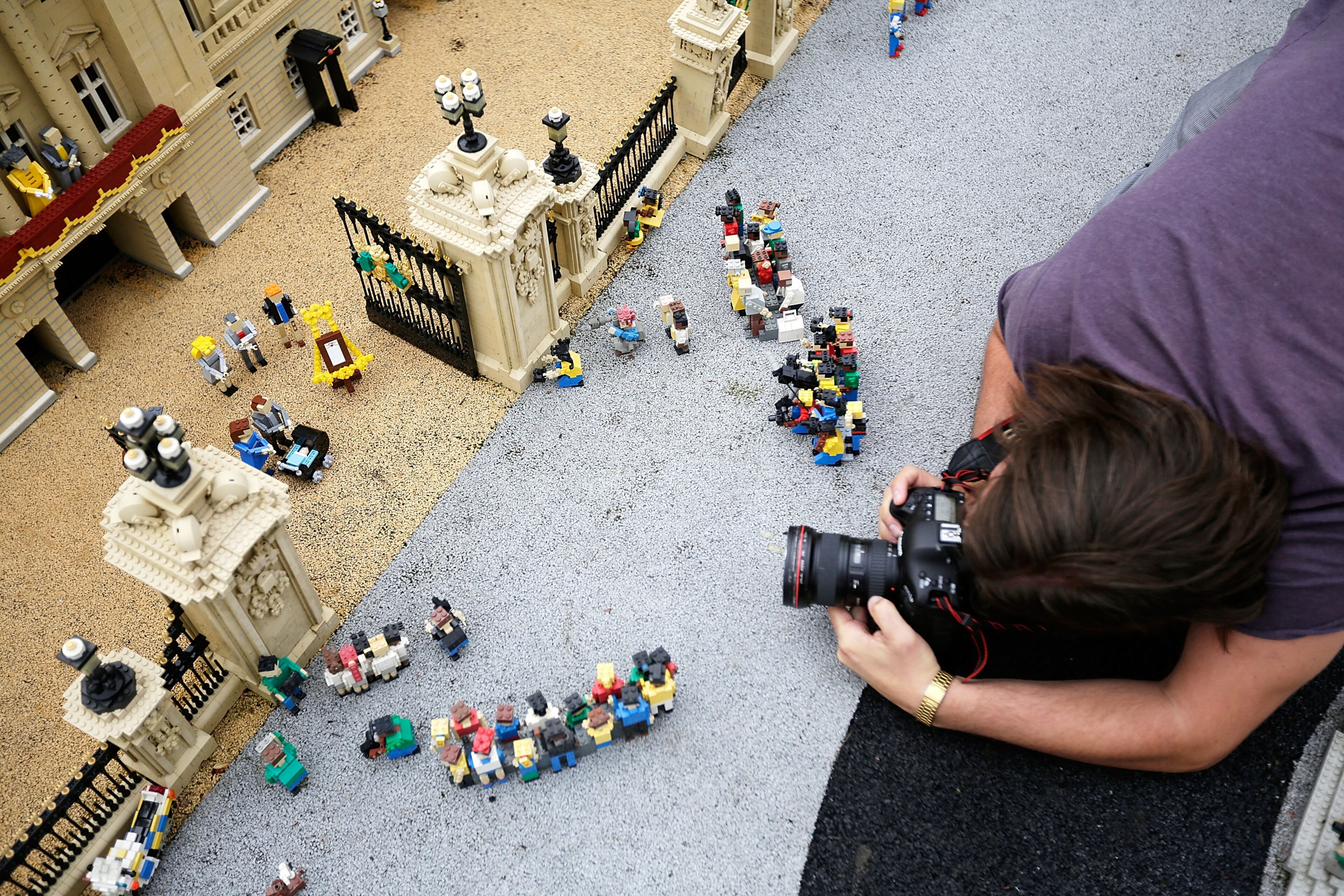 WINDSOR, ENGLAND - JULY 25: Lego models of the Royal family and well-wishers outside a model of Buckingham Palace, part of a new attraction created to commemorate the birth of HRH Prince George of Cambridge at the Legoland resort on July 25, 2013 in Windsor, England. Model maker Katrina James constructed the baby and pram model out of 55 bricks, with the palace made out of 36,000 bricks. Catherine, Duchess of Cambridge gave birth to HRH Prince George of Cambridge at 16.24 BST on Monday July 22, 2013 with Prince William, Duke of Cambridge at her side. (Photo by Matthew Lloyd/Getty Images)