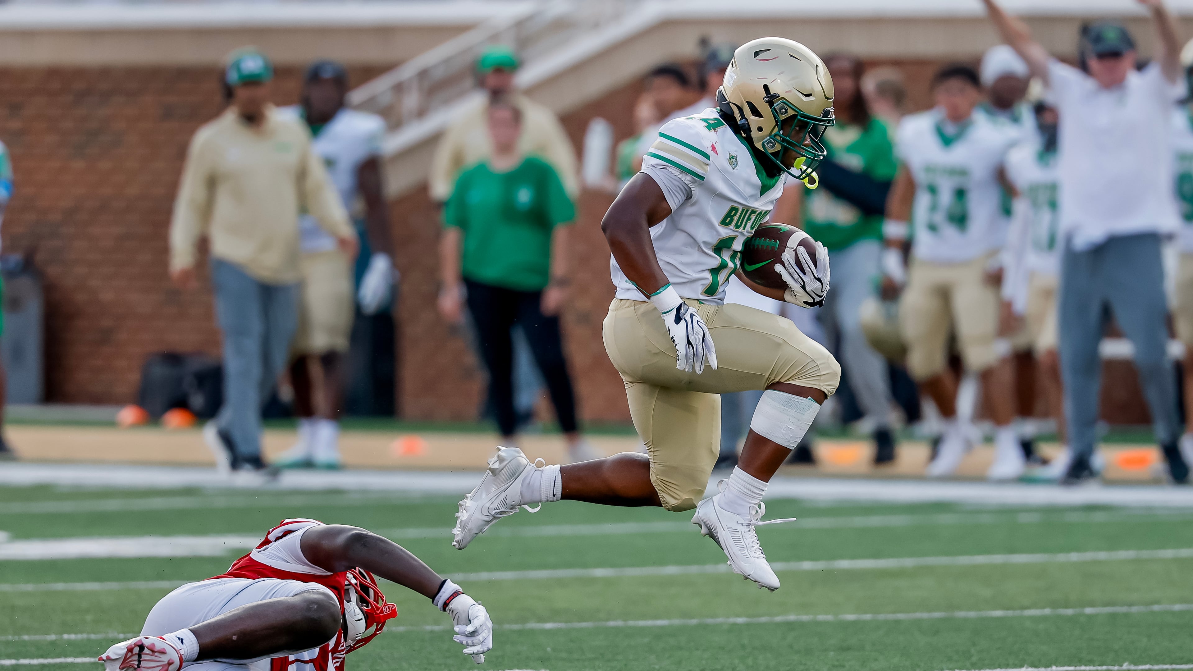 BufordÕs Tripp Chatmon (14) breaks away from Gainesville defender for a touchdown run during the second half of a high school football game between Buford and Gainesville, Saturday, Aug. 22, 2026, in Buford, GA. (Erik S. Lesser for the AJC)